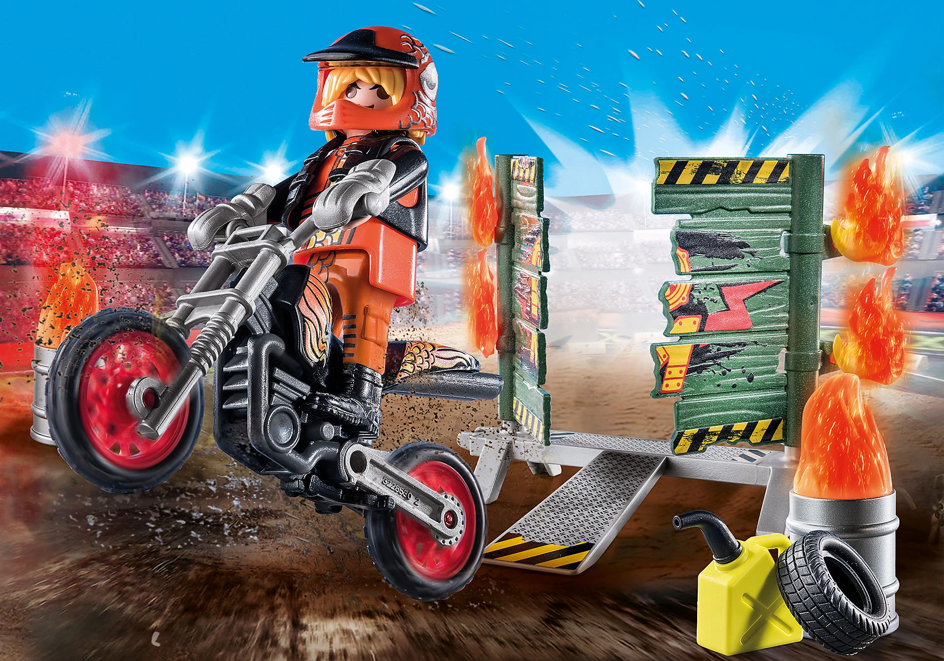 Ein Spielzeugmotorradfahrer auf einem Motorrad springt über eine Rampe und Hindernisse. Flammen und ein Stadion sind im Hintergrund.