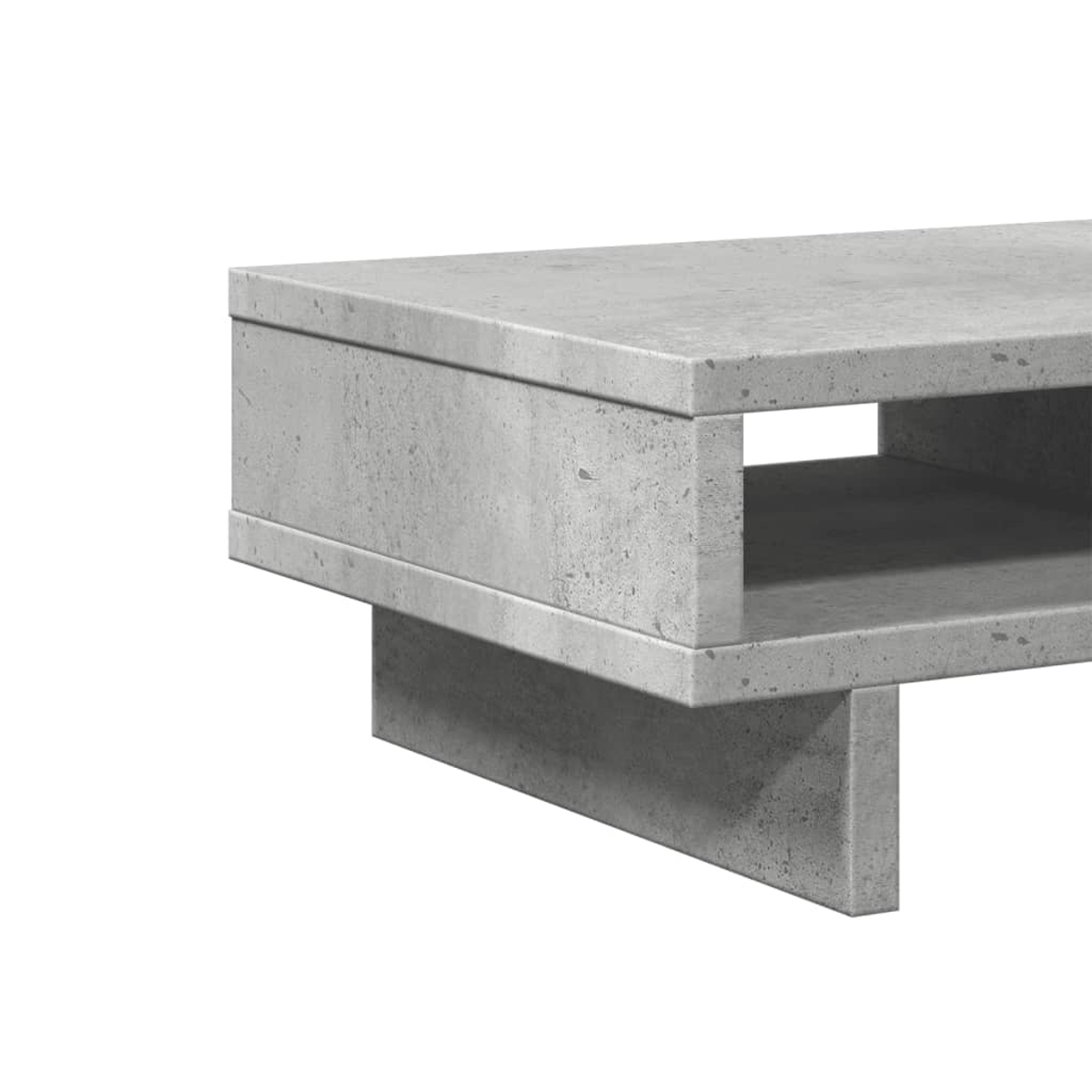 Nahaufnahme eines modernen Couchtischs aus Beton. Er ist grau, rechteckig und hat einen ausgehöhlten Bereich.