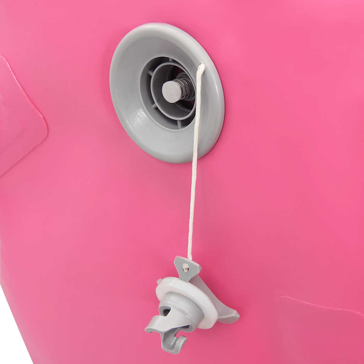 Nahaufnahme eines rosa aufblasbaren Gegenstands mit einem grauen Ventil. Eine weiße Schnur führt zu einem Ventilstöpsel.