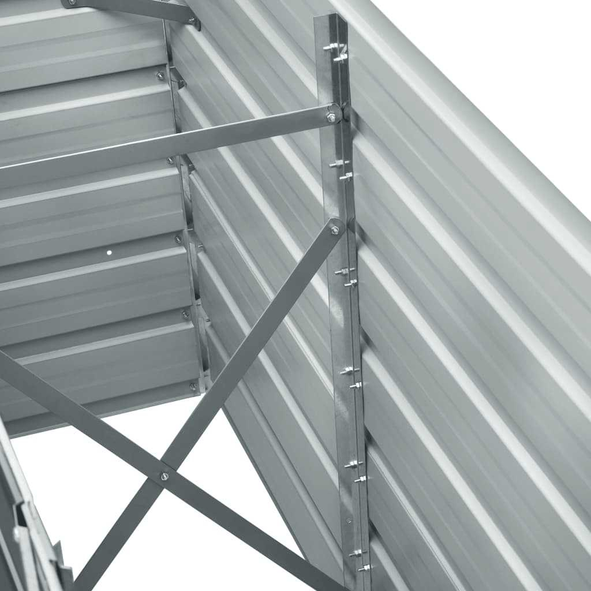 Nahaufnahme einer Metallkonstruktion. Diagonale und horizontale graue Metallträger und -platten werden durch Bolzen und Nieten verbunden.