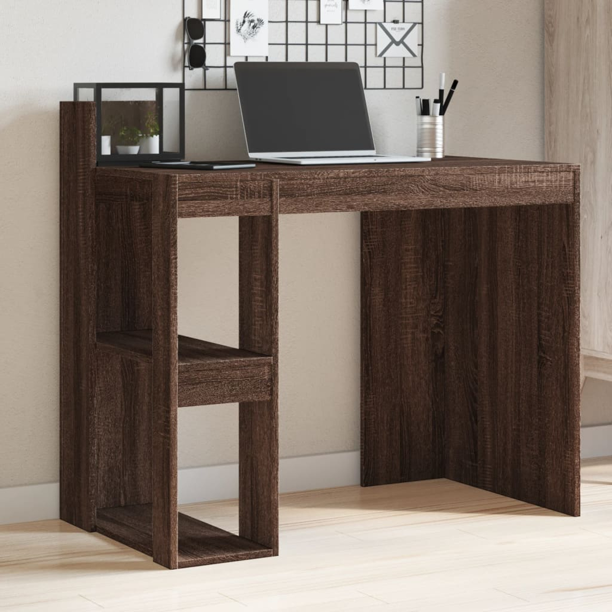 Ein Holzschreibtisch mit Laptop, Stiften und einer Gittertafel. Der Schreibtisch hat eingebaute Regale. Der Hintergrund ist eine helle Wand und ein heller Boden.
