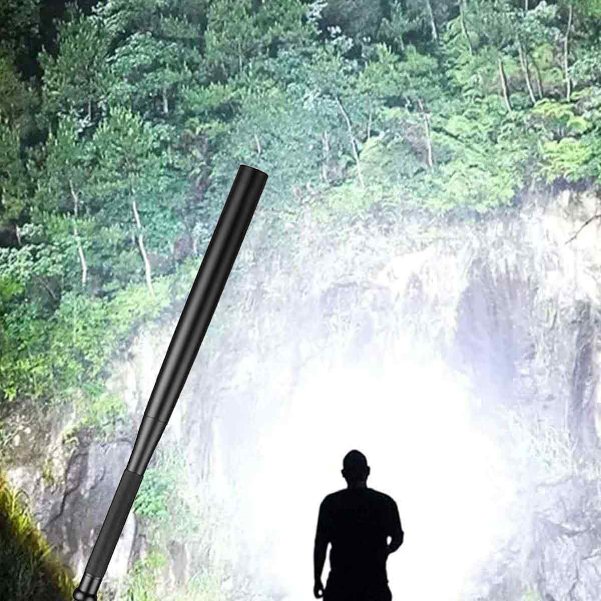 Eine Person steht vor einer hellen Lichtquelle. Ein schwarzer Baseballschläger wird diagonal gehalten. Bäume und eine Felswand sind sichtbar.
