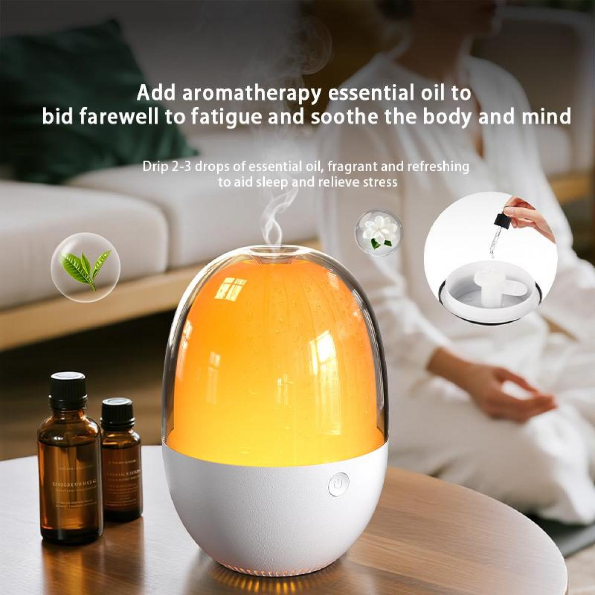 Aromatherapie-Setup: Diffusor, ätherische Ölflaschen und Hand, die Öl tropft. Im Hintergrund sitzt eine Person.