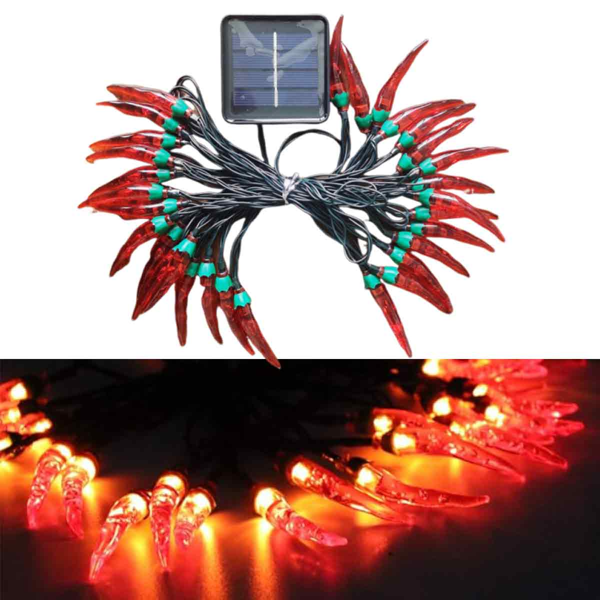 Lichterketten in Form roter Chilischoten mit grünen Basen, verbunden mit einem Solarpanel. Lichter sind an und orangefarben.