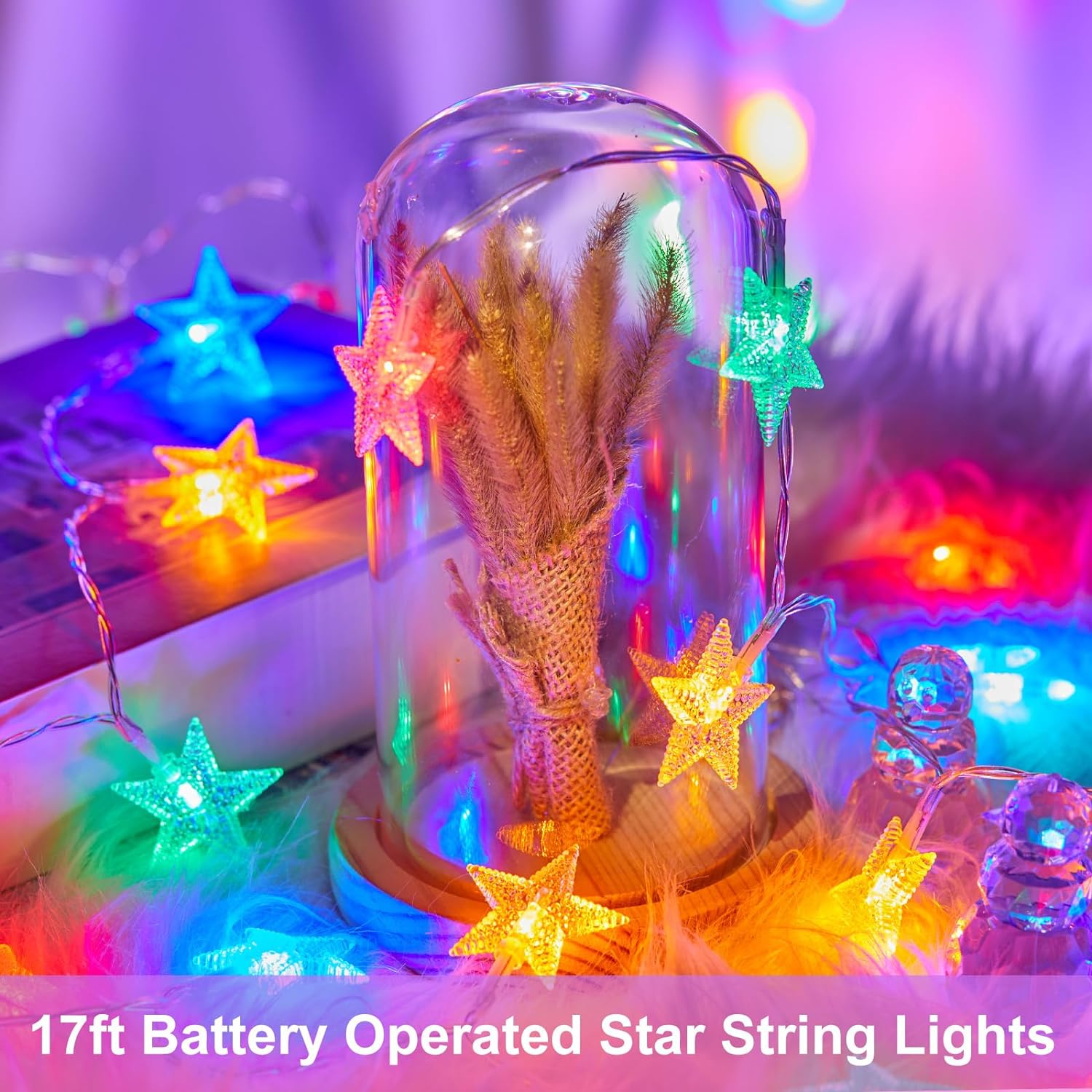 Eine Glaskuppel mit sternförmigen Lichterketten und getrockneten Blumen, mit verschwommenem, farbenfrohem Hintergrund und Text: "17ft Battery Operated Star String Lights".