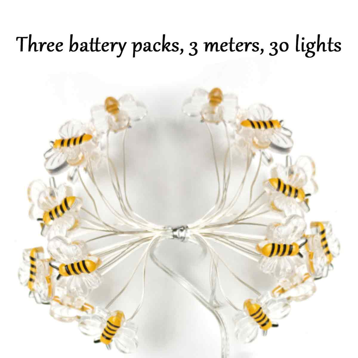 Dekorative Lichterkette mit bienenförmigen Ornamenten und kleinen Lichtern. Weißer Hintergrund mit Produktinformationen.