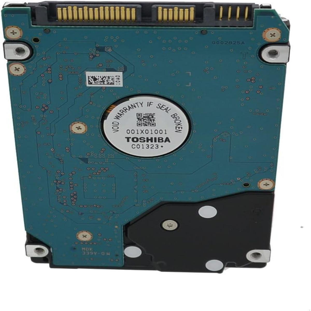 Un circuito stampato con un adesivo Toshiba. La scheda è verde acqua con vari componenti e un connettore nero in alto. Testo: void warranty.