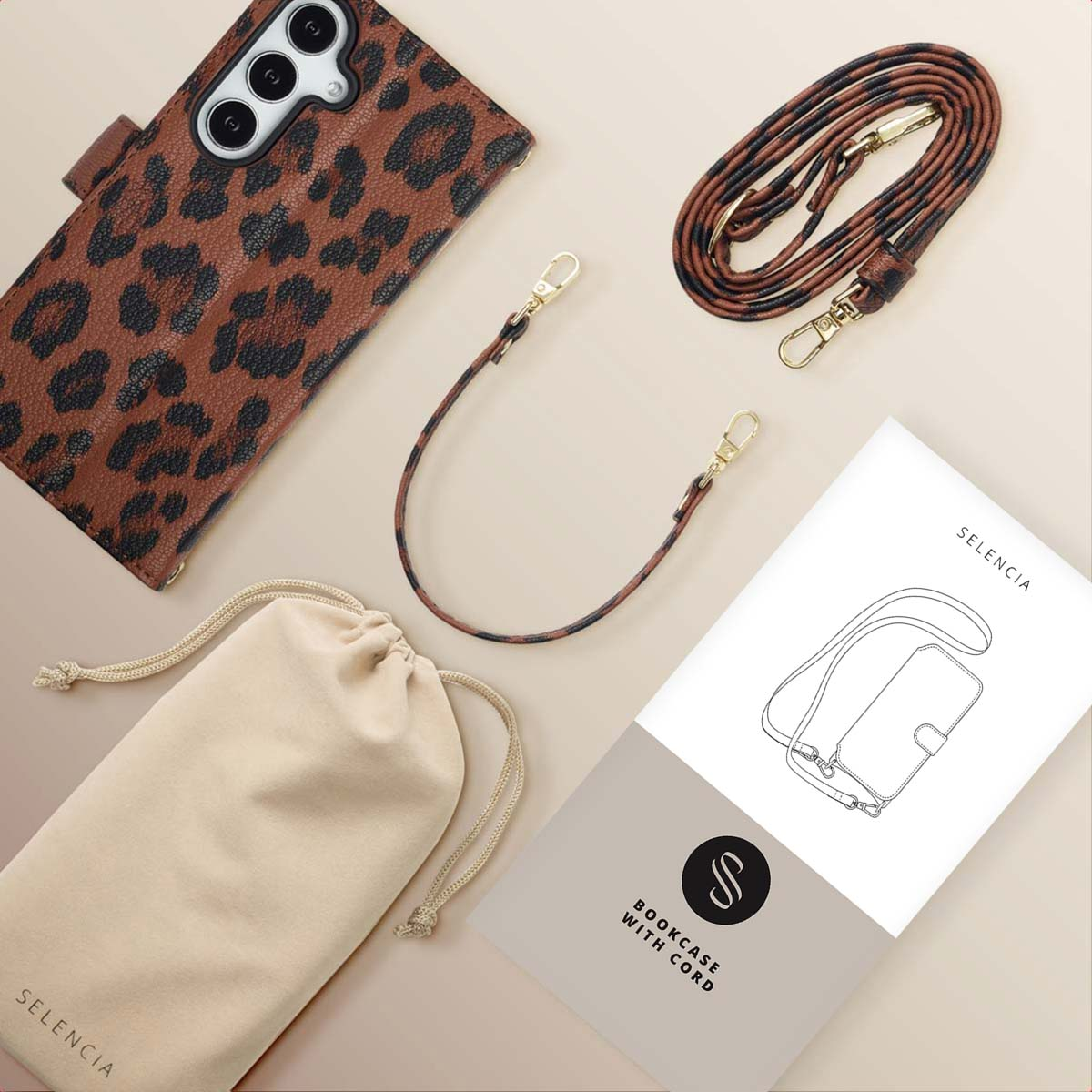 Telefoonhoesje met luipaardprint, riem, etui en boekje. Hoes en riem hebben gouden hardware. Achtergrond is een neutrale kleur.