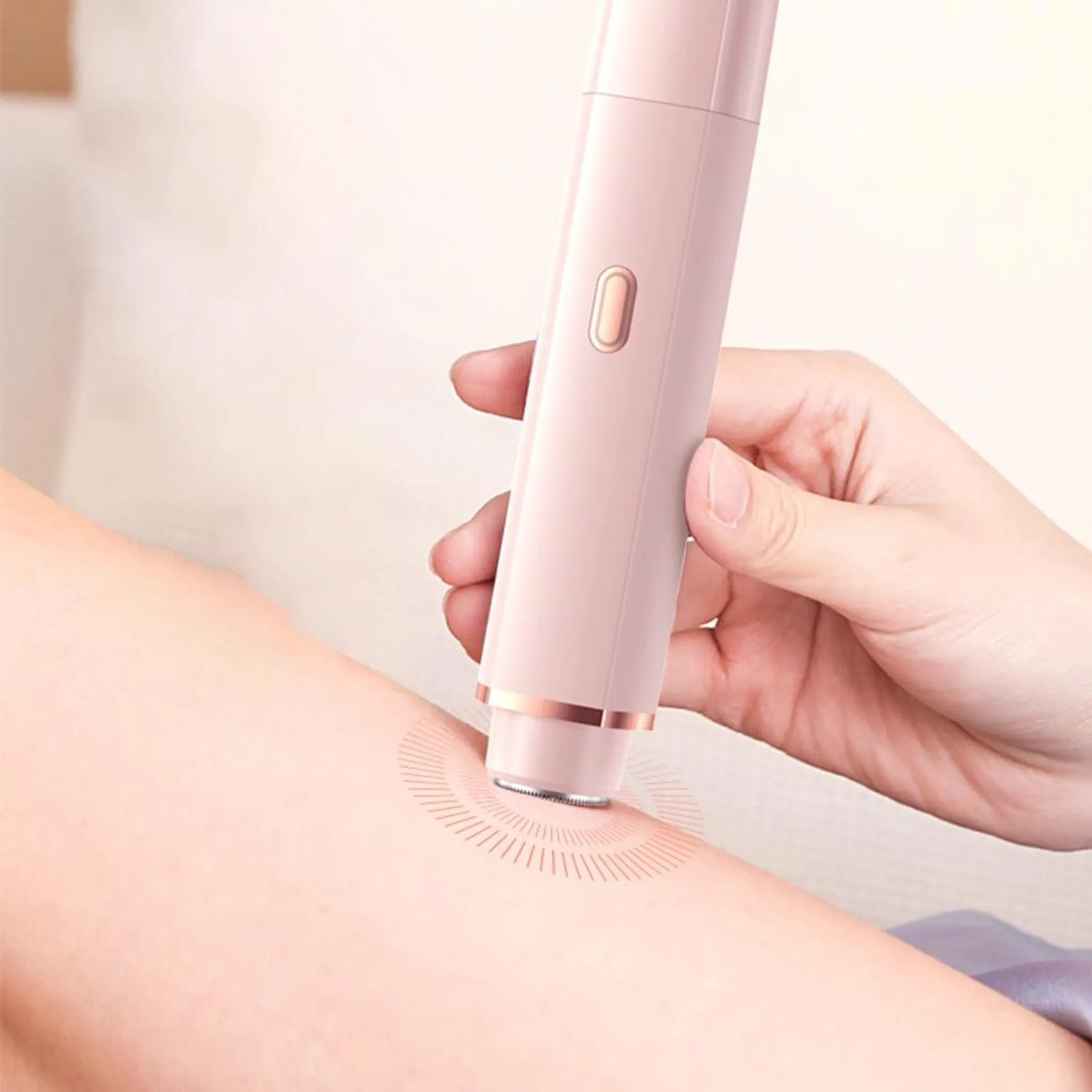 Eine Hand hält einen rosa elektrischen Rasierer gegen ein Bein. Der Rasierer wird auf der Haut verwendet, was einen visuellen Effekt erzeugt.