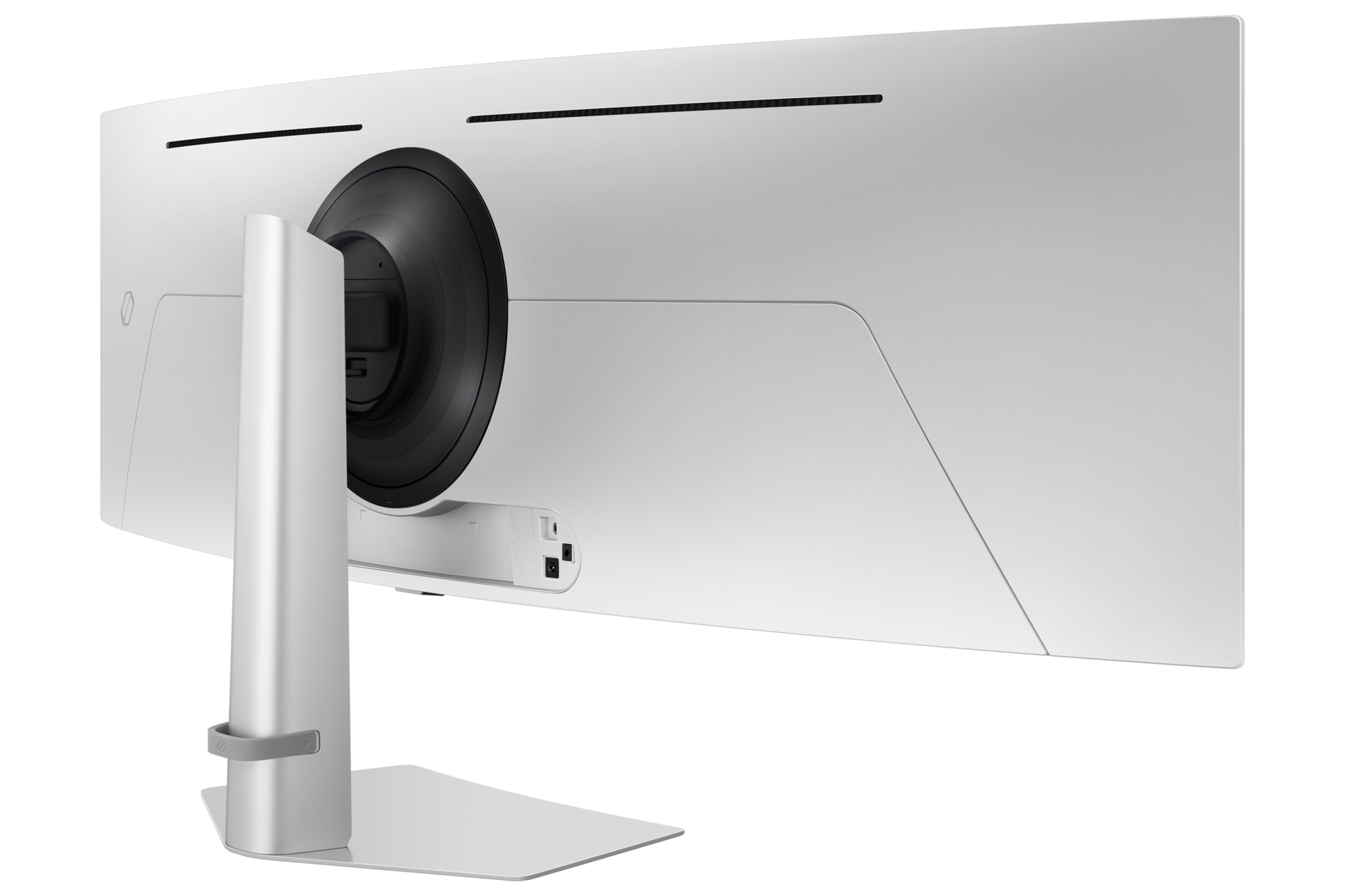 Widok z tyłu białego zakrzywionego monitora. Posiada podstawę i duży czarny okrągły element pośrodku.