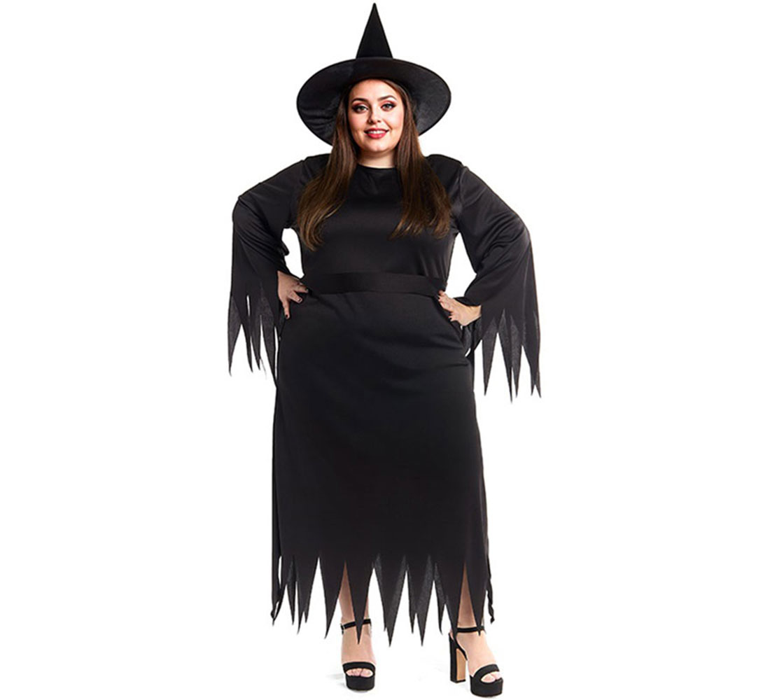 Una mujer con un disfraz de bruja negro sonríe a la cámara. Lleva un sombrero puntiagudo, un vestido largo y tacones altos.