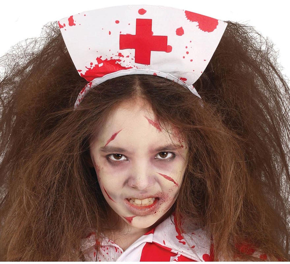 Una niña con disfraz de enfermera, maquillaje de sangre y una cruz ensangrentada en el sombrero, mira al espectador con enojo.