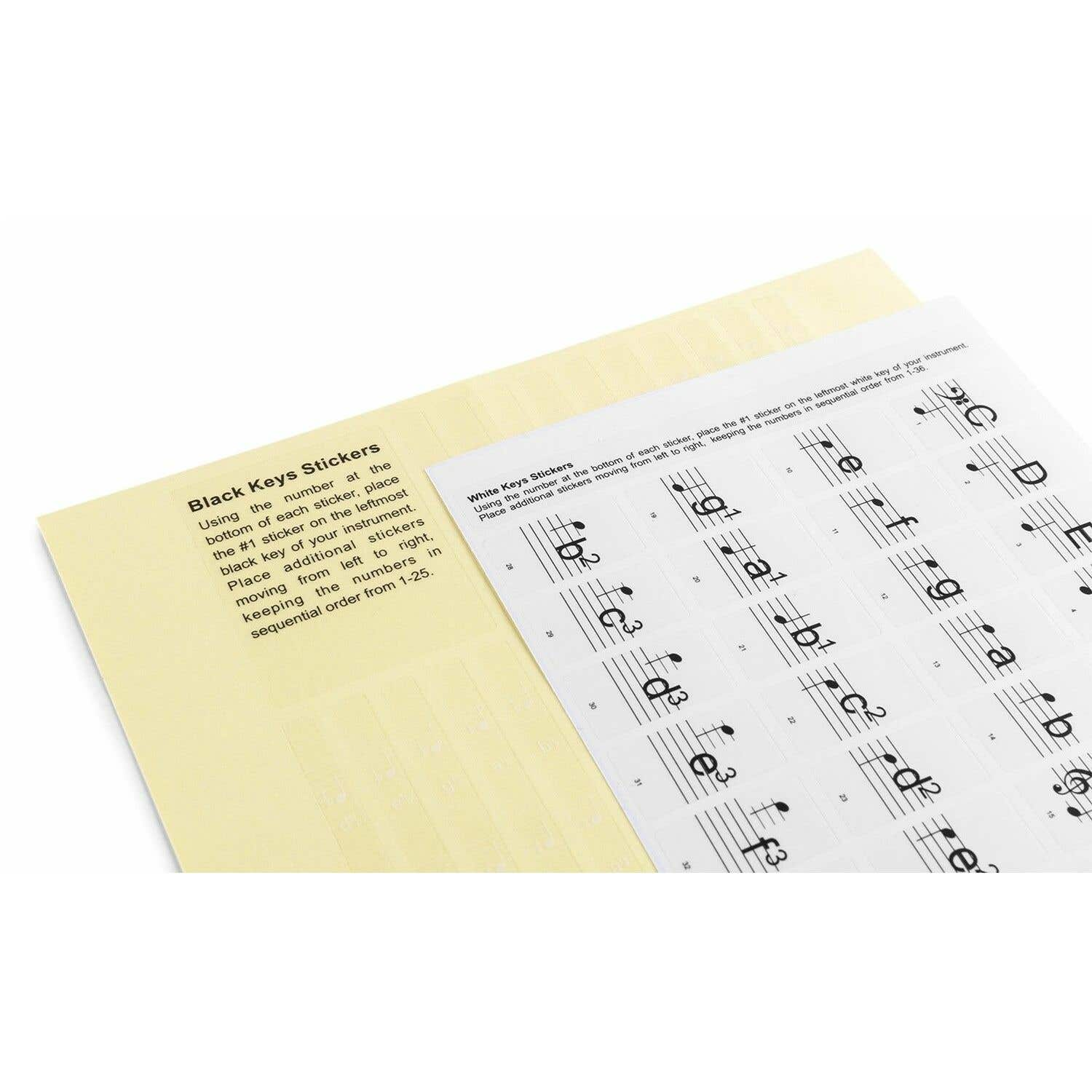Imagen muestra pegatinas de notas musicales con instrucciones. El texto incluye descripciones de 'Black Keys Stickers' y 'White Keys Stickers'.