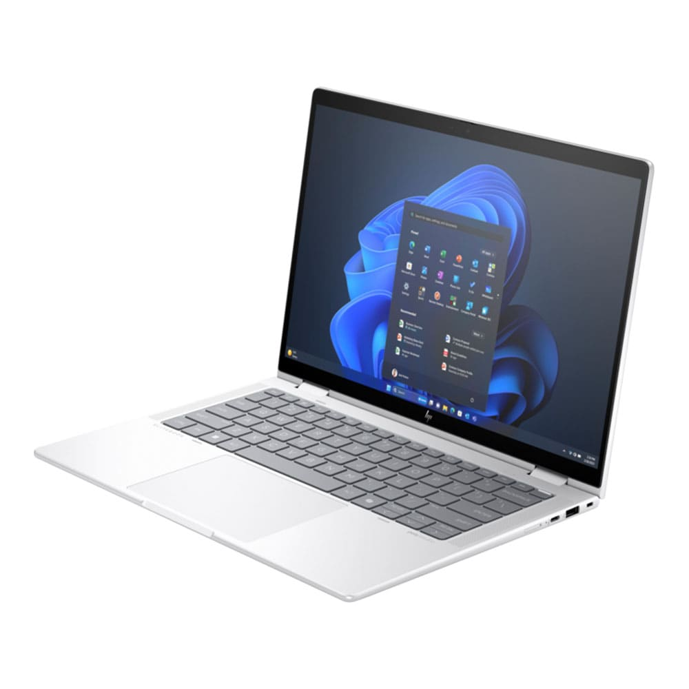 Gümüş renkli HP dizüstü bilgisayar açık, Windows 11 arayüzü görünür. Ekran uygulamaları gösterir. Klavye ve dokunmatik yüzey de görünür.