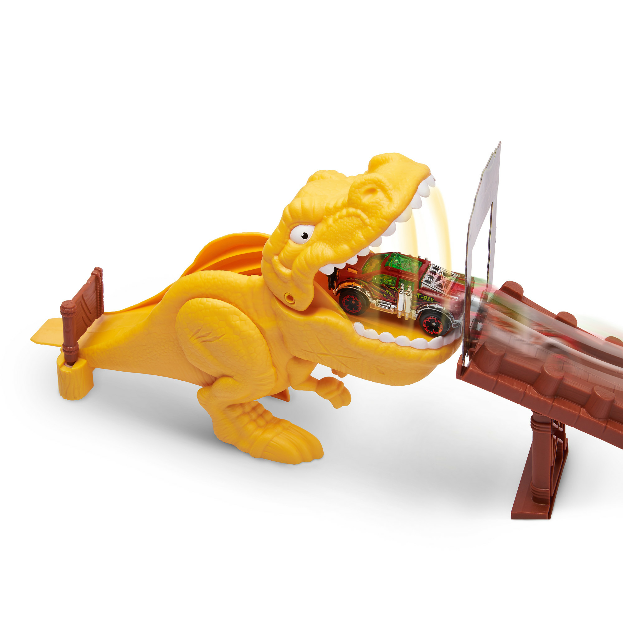 Juguete de dinosaurio amarillo con un coche en la boca. El coche se dirige a una pista marrón.