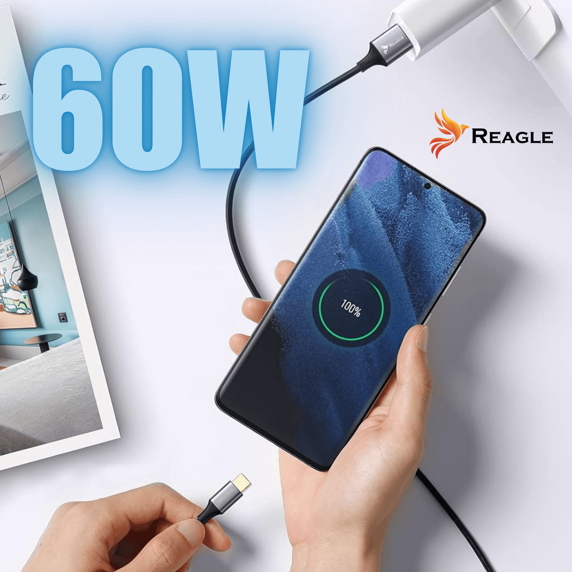 Telefon ładujący się kablem. Telefon pokazuje 100% naładowania. Wyświetlono 60W. Widoczne logo Reagle.