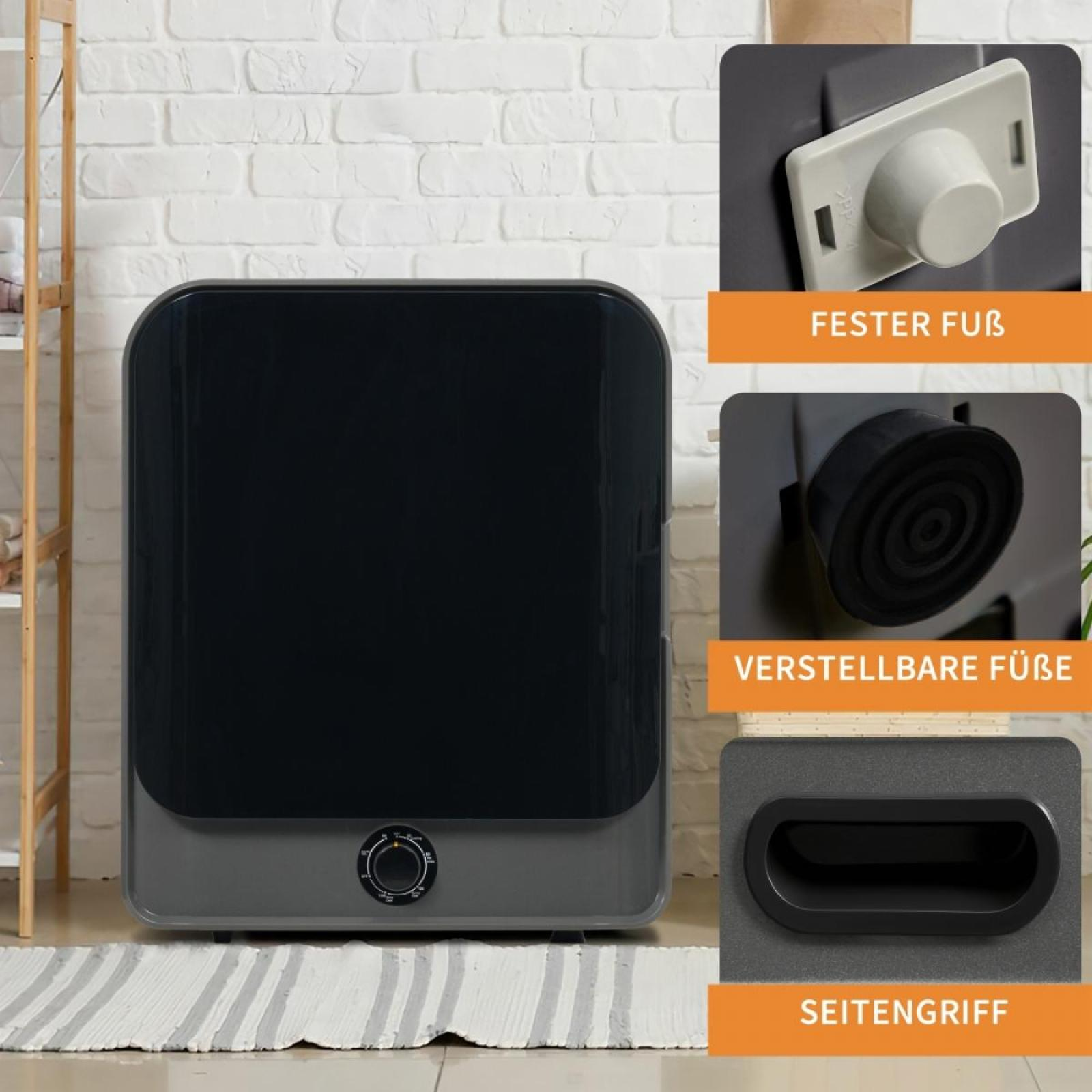 Ein schwarzes und graues Gerät mit einem Bedienknopf. Details zeigen Füße und Griff. Weiße Backsteinmauer im Hintergrund.