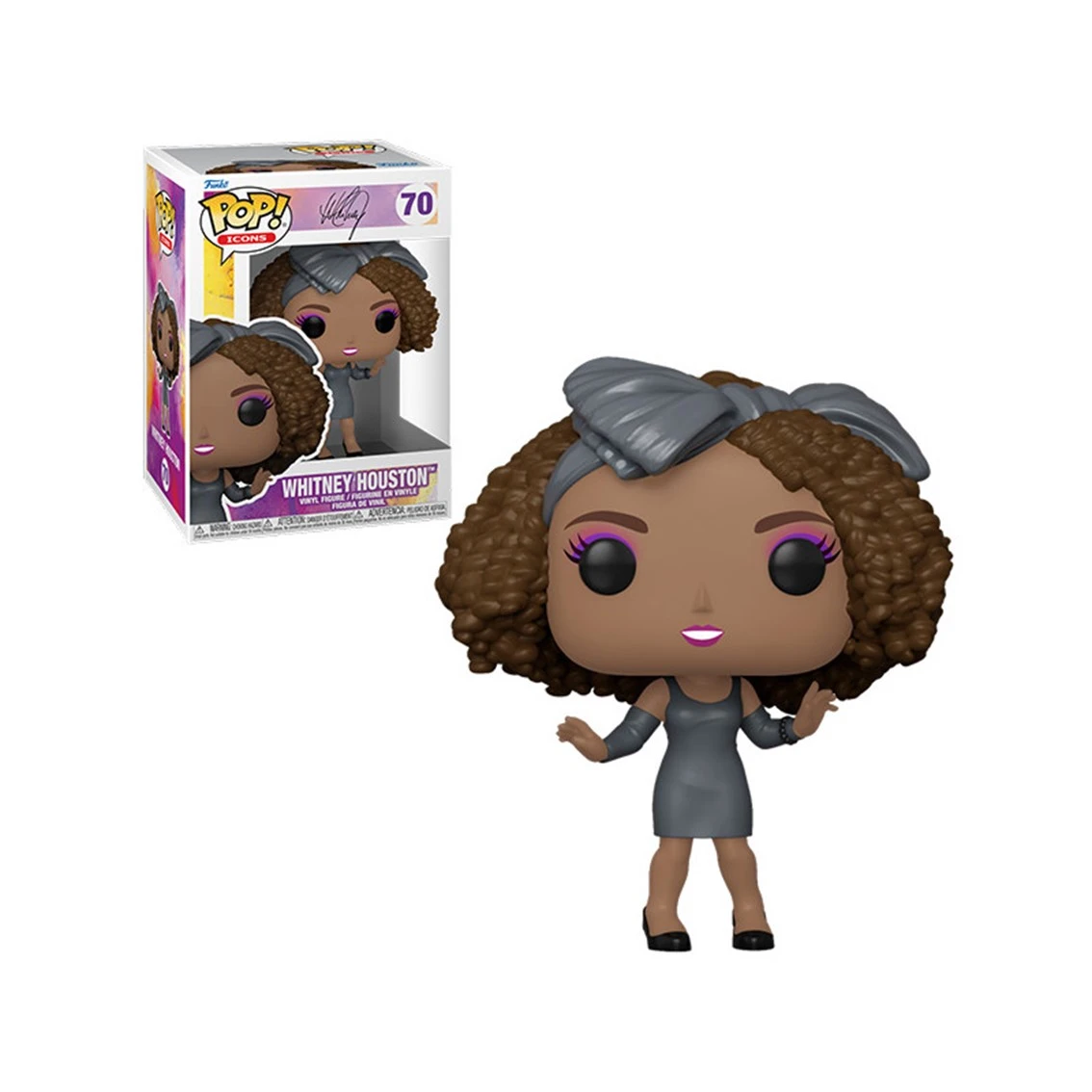 Figurka Funko Pop Whitney Houston. Ma na sobie szarą sukienkę i kokardę. Po lewej stronie znajduje się pudełko z tą samą figurką.