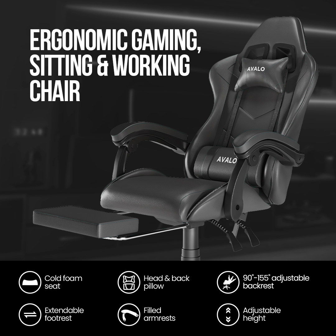 Black ergonomic gaming chair with headrest, lumbar pillow, and footrest. Features cold foam seat, adjustable height and backrest.