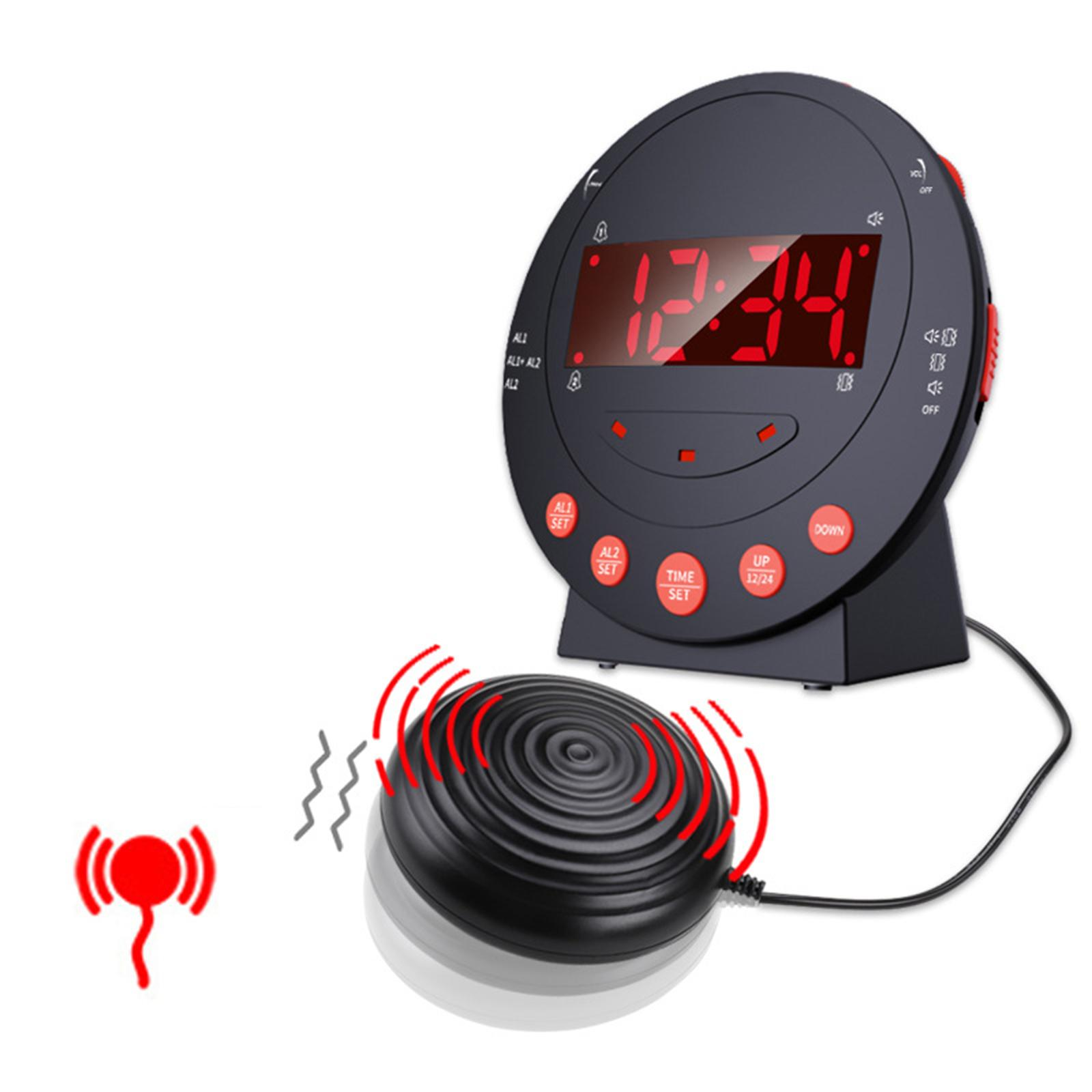 Schwarzer Wecker mit roter Anzeige, die die Zeit anzeigt. Ein Vibrationspad ist angebracht. Alarmsymbol wird gezeigt.