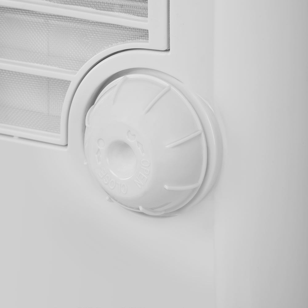 Primer plano de una perilla de control blanca con marcas 'OPEN' y 'CLOSE'. Es parte de un aparato blanco, con una ventilación visible en el fondo.
