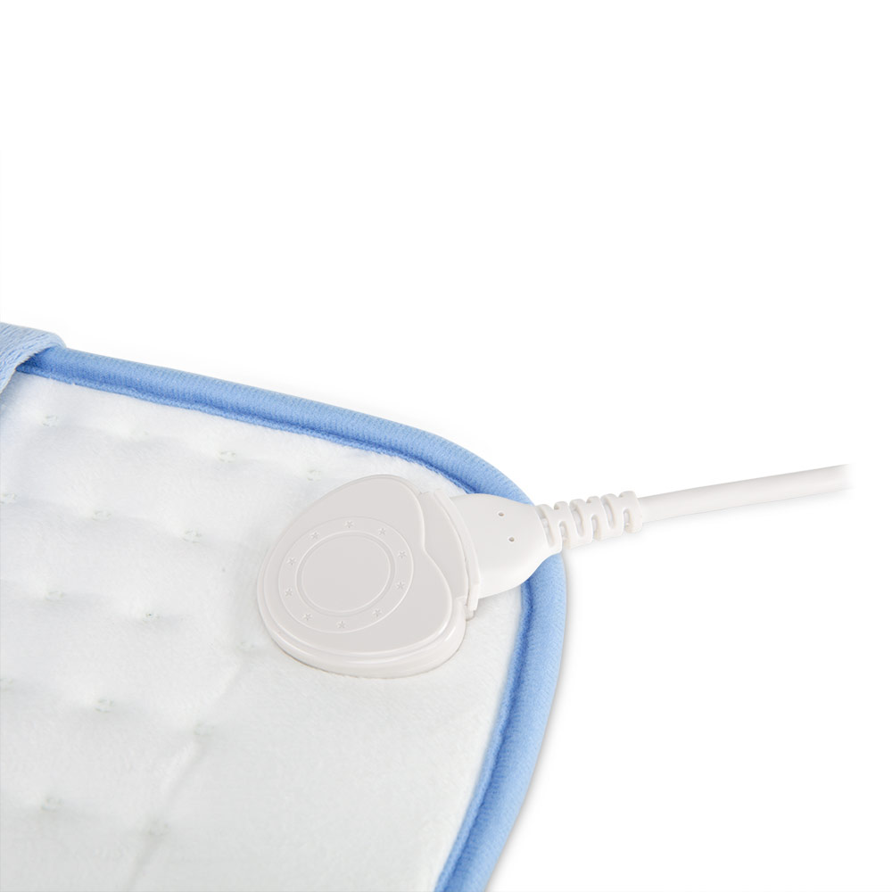 Biała poduszka grzewcza z niebieską obwódką oraz białym, w kształcie serca złączem i kablem. Poduszka jest na białym tle.