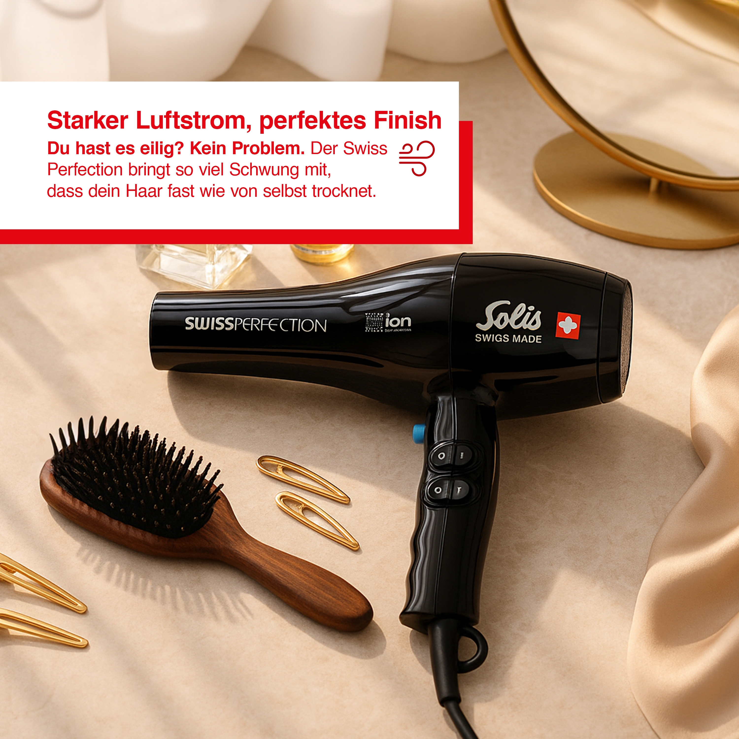 Czarna suszarka, drewniana szczotka i dwie złote spinki na beżowej powierzchni.