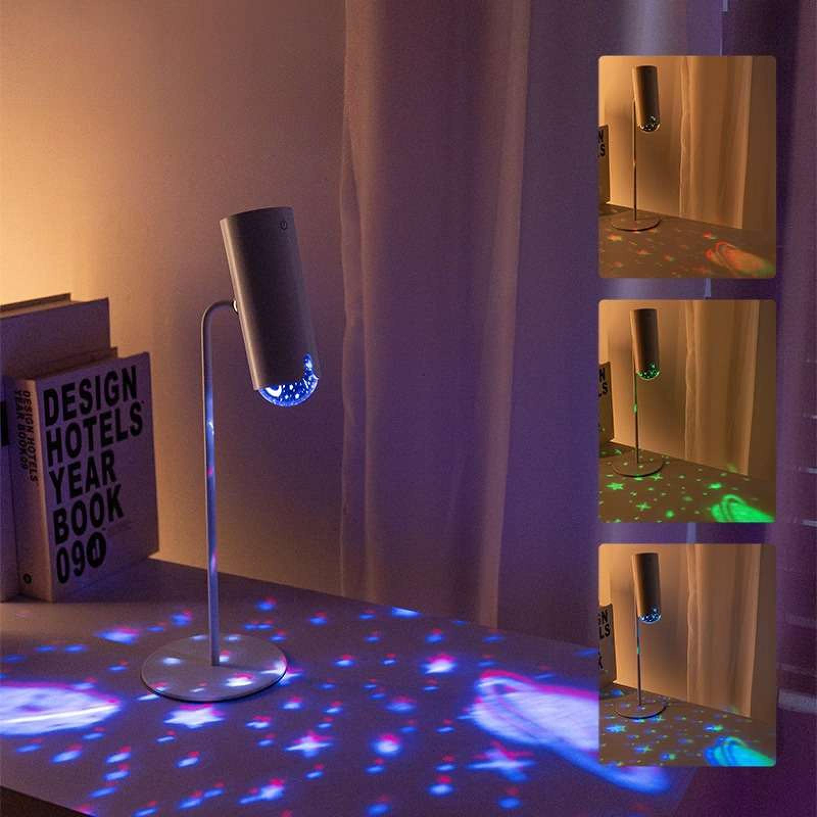 Eine moderne Lampe projiziert farbenfrohes Licht auf die Oberfläche. Links sind Bücher, rechts ein Vorhang.