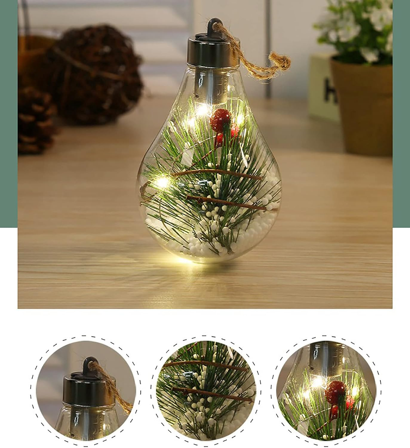 Ein klarer, tropfenförmiger Glasornament mit Lichtern, Tannennadeln, roten Beeren und weißen Perlen. Es hängt an einer Juteschnur.