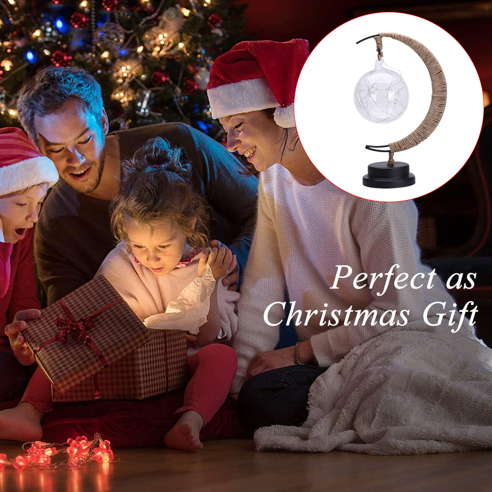 Eine Familie öffnet ein Weihnachtsgeschenk. Ein Weihnachtsbaum und eine mondförmige Lampe sind im Hintergrund sichtbar. Die Szene ist warm und festlich.