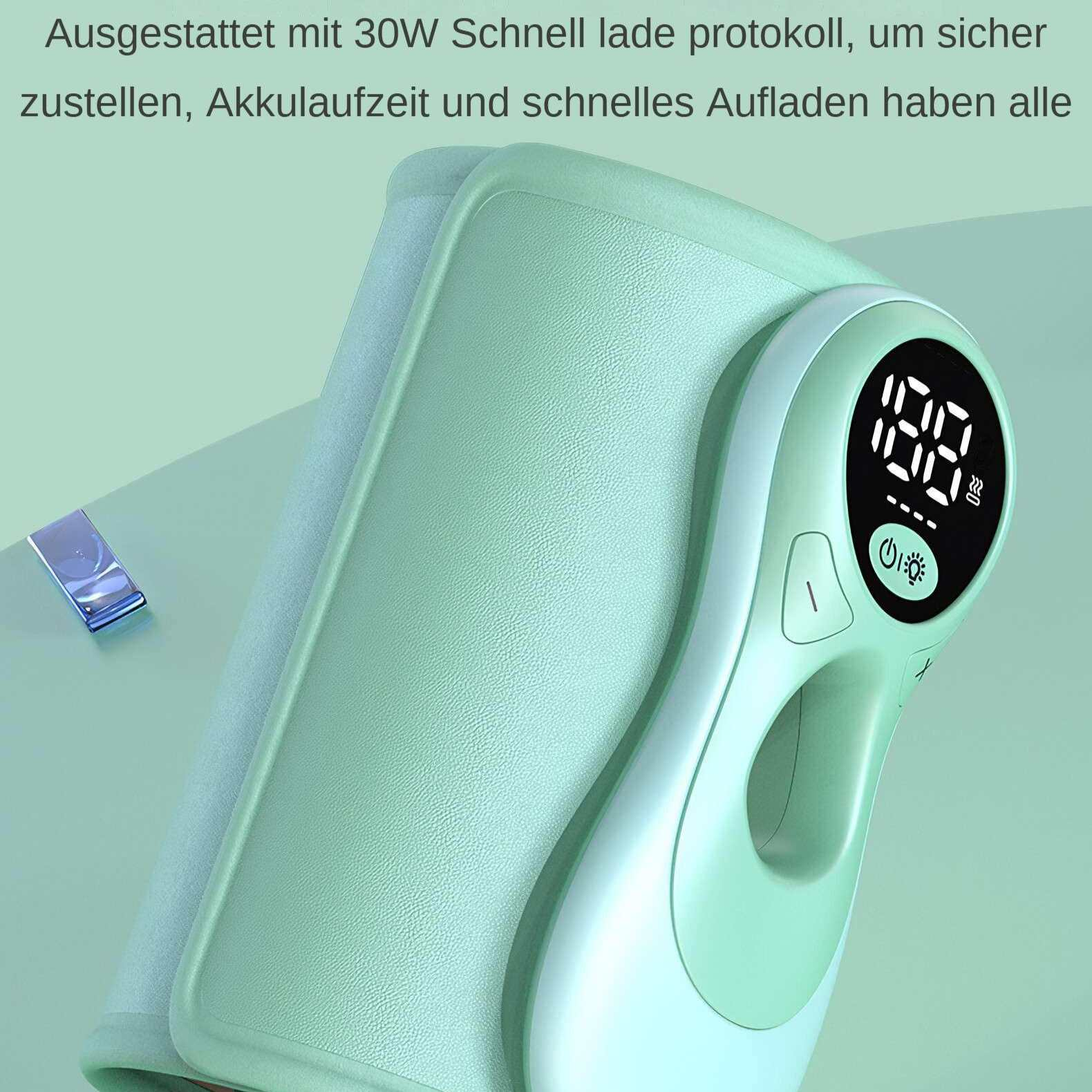 Ein grünes medizinisches Gerät mit Digitalanzeige zeigt Zahlen. Ein kleines, blaues, rechteckiges Objekt ist vorhanden.