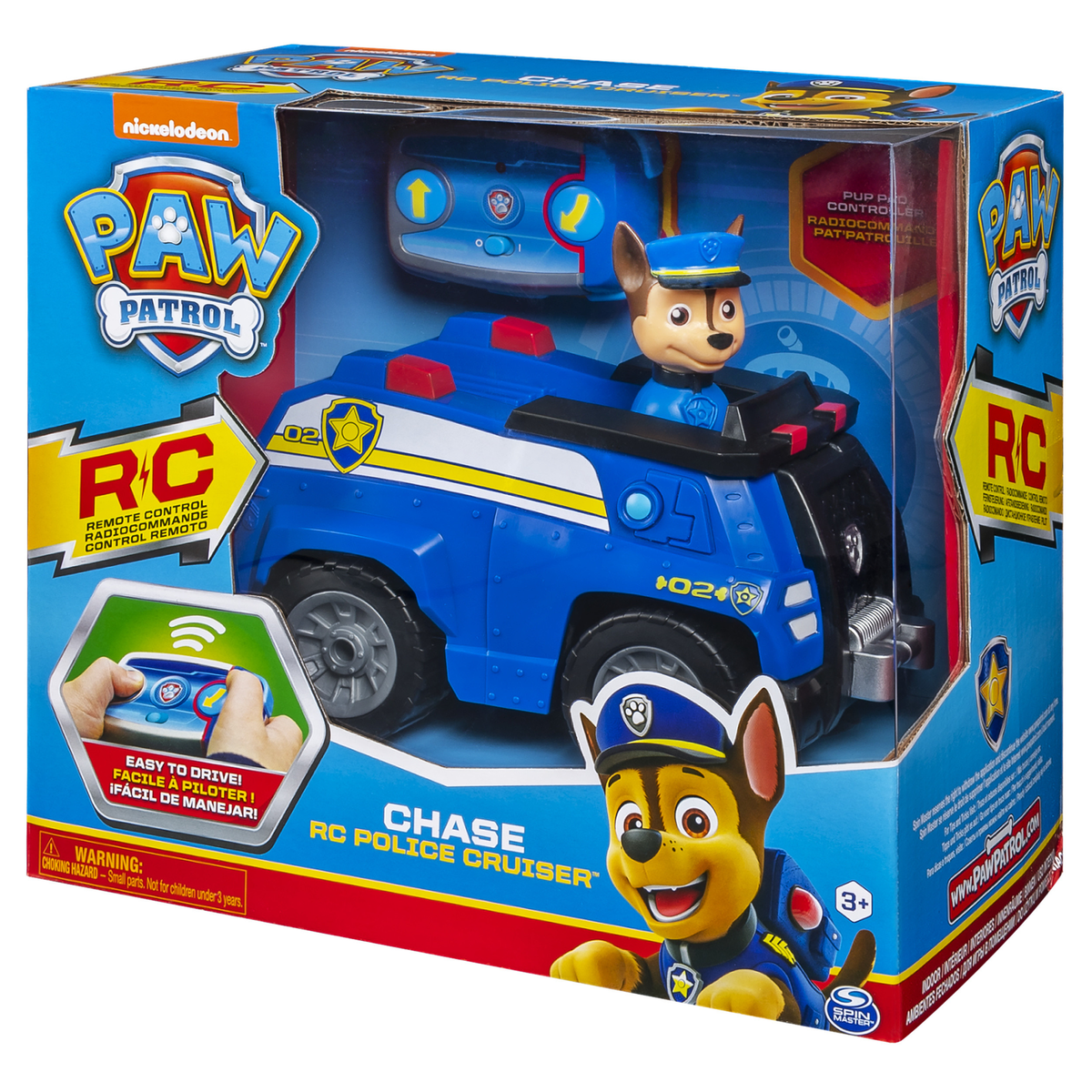 Un juguete de patrulla canina Chase RC police cruiser en una caja. La caja muestra el juguete, un mando a distancia y Chase el perro.