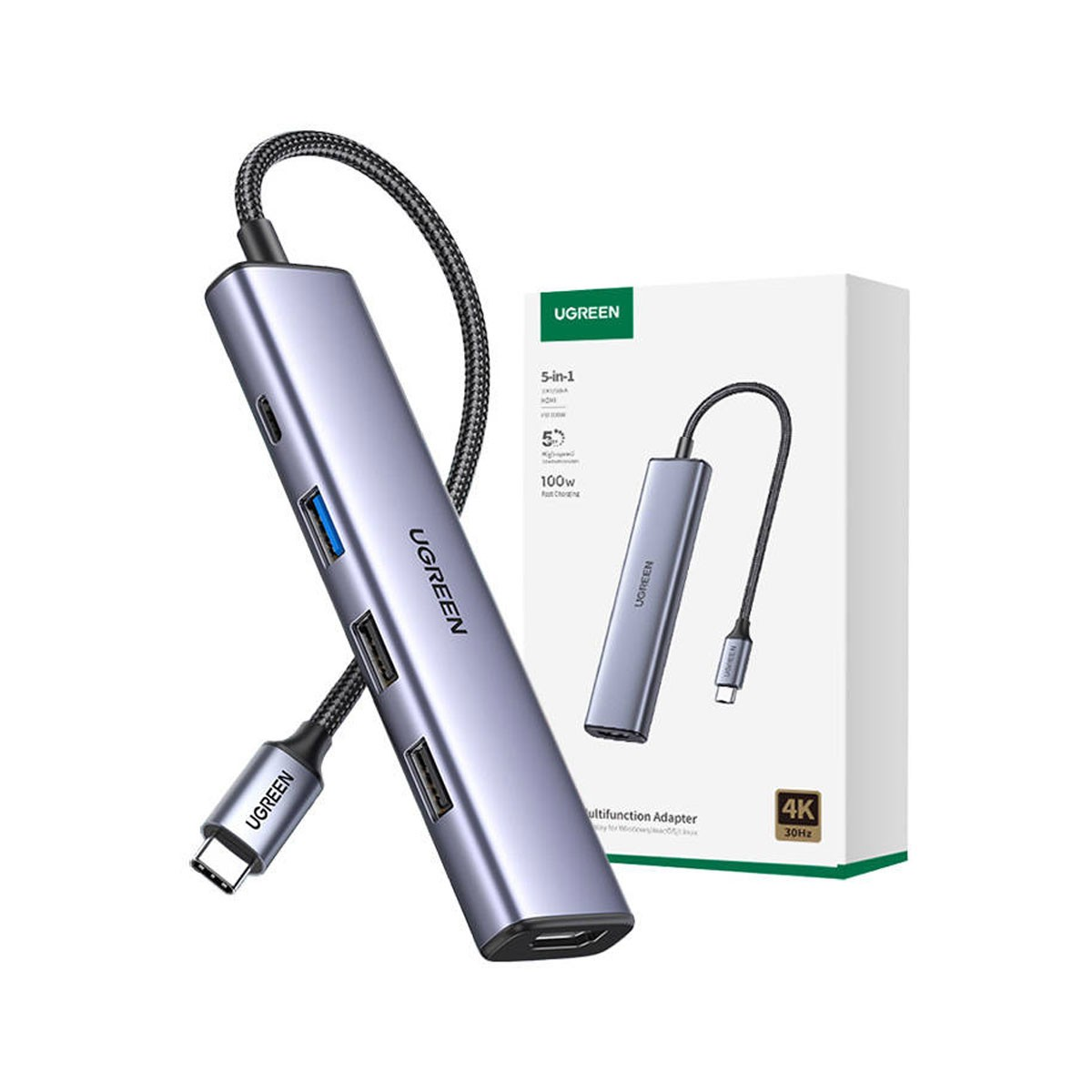 Wyświetlany jest adapter UGREEN 5-w-1 USB-C. Jest srebrny z wieloma portami, a na pudełku widać inny adapter.
