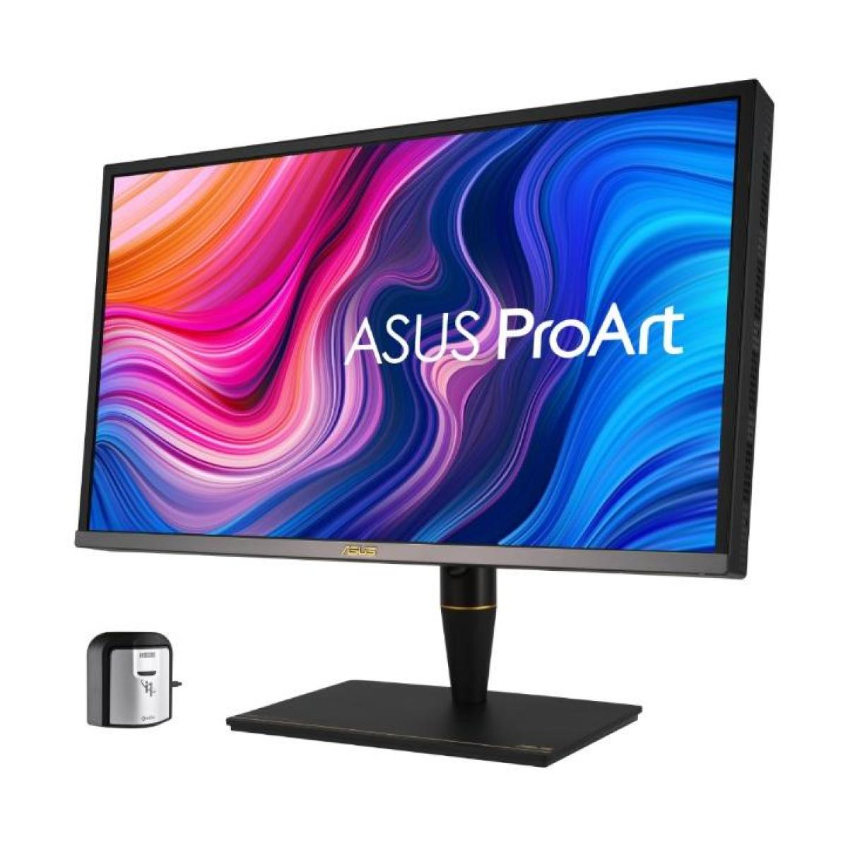 Monitor ASUS ProArt wyświetlający kolorowy abstrakcyjny obraz. Małe czarne urządzenie znajduje się pod monitorem.