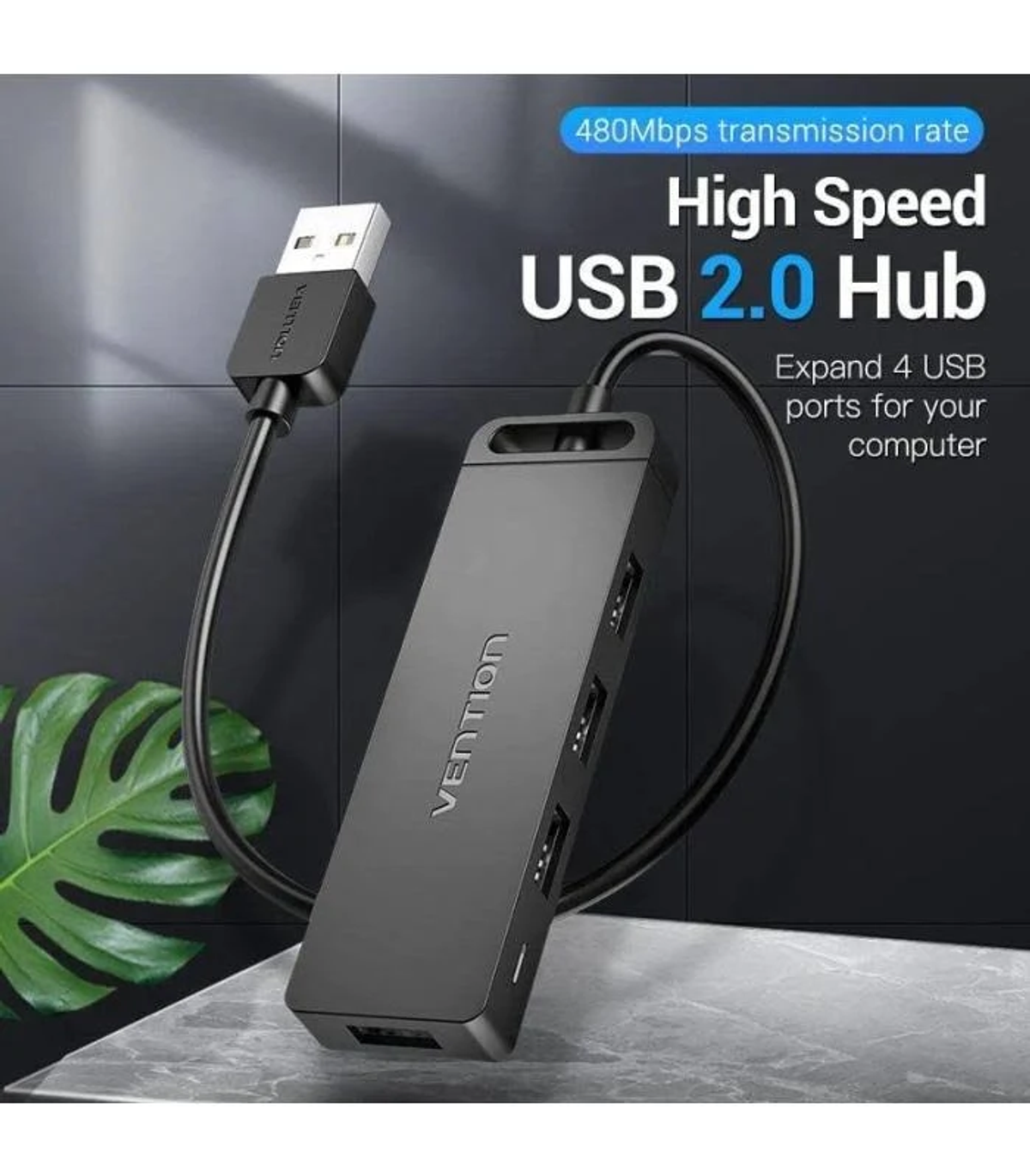 Concentrador USB negro con cable adjunto. Texto: 'High Speed USB 2.0 Hub'. Fondo: hojas y superficie de mármol.