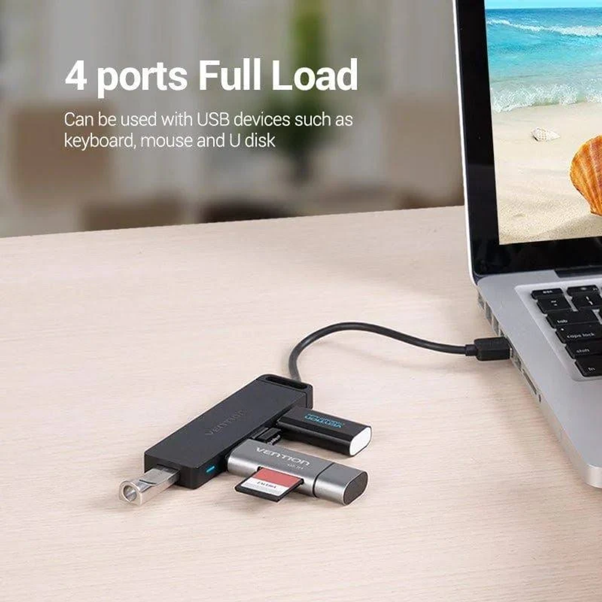 Un portátil conectado a un concentrador USB con una unidad flash y un lector de tarjetas SD. La pantalla muestra una escena de playa.