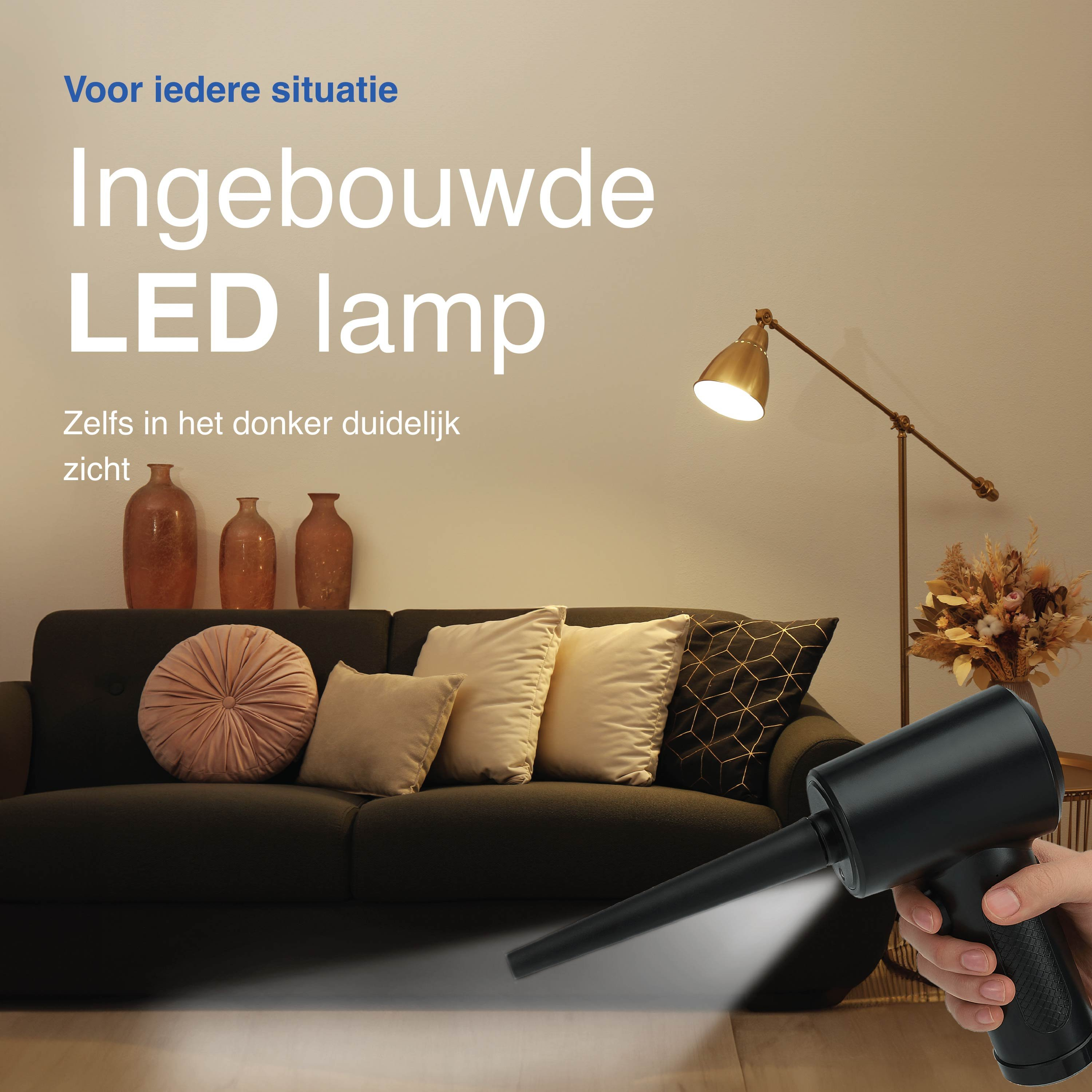 Living room scene with a built-in LED lamp. A hand holding a black device. Sofa, pillows, floor lamp, and vases are visible.