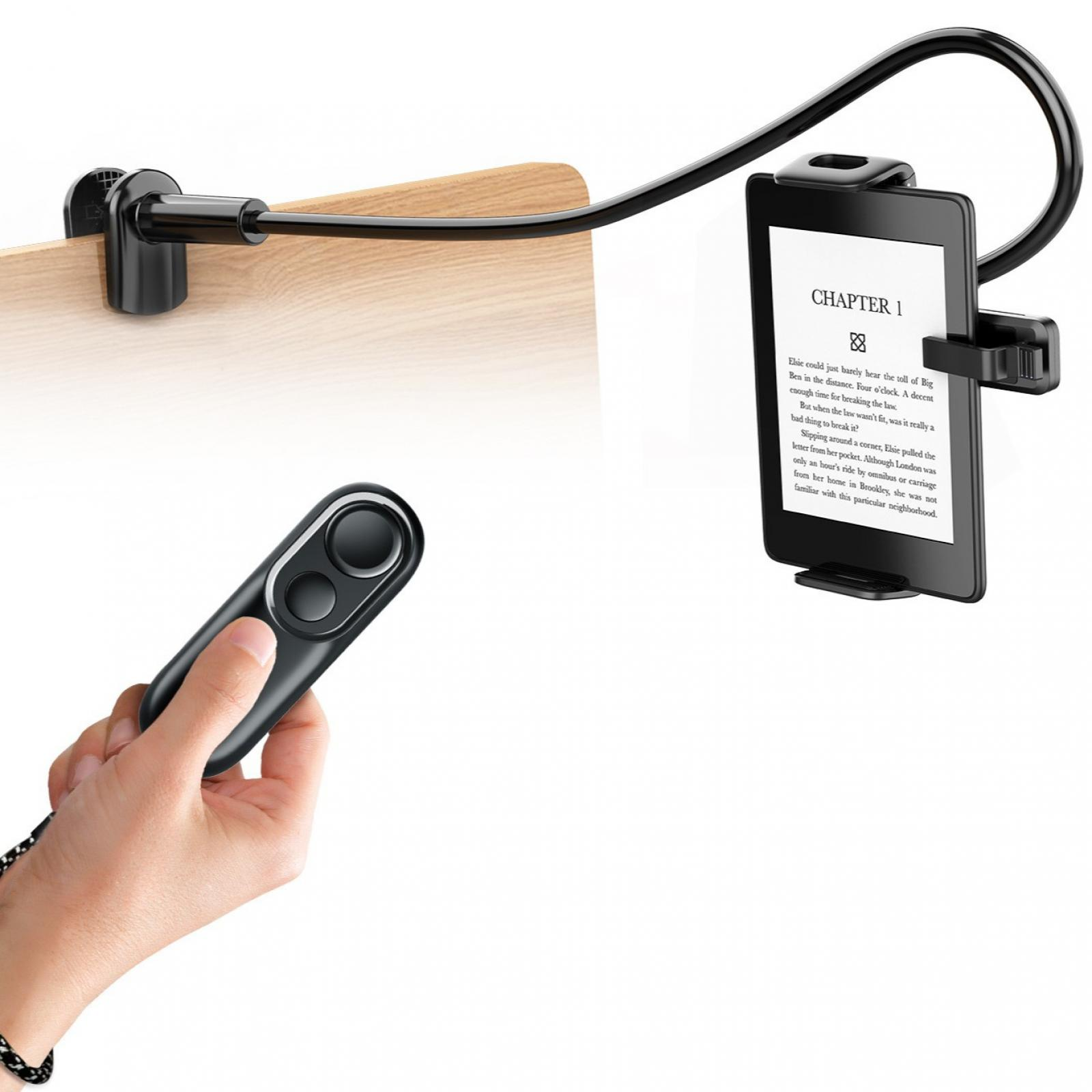 Ein schwarzes Tablet wird von einem flexiblen Arm gehalten, der an einer Holzoberfläche befestigt ist. Eine Hand hält eine schwarze Fernbedienung.