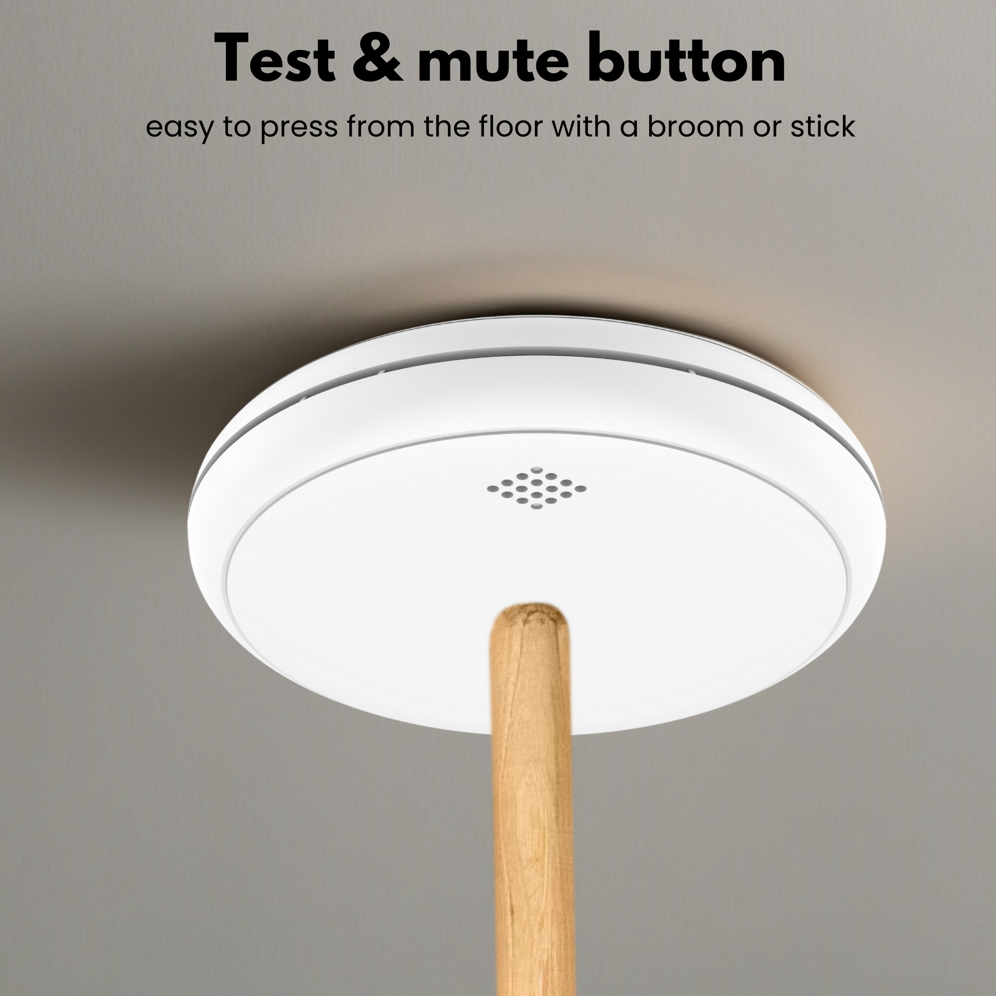 A white ceiling-mounted device with a wooden stick. The device has a test and mute button. Text indicates easy floor access.