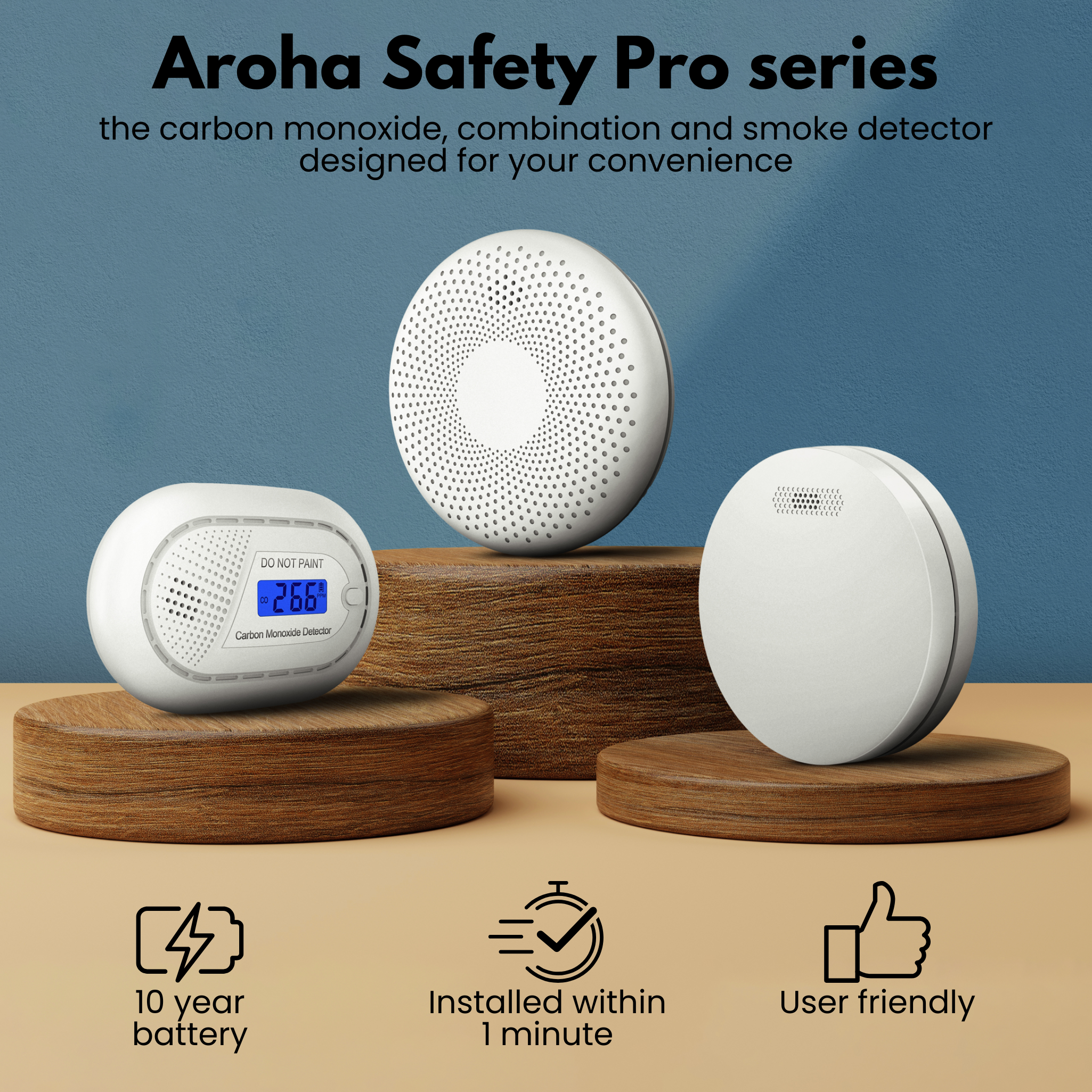Three white carbon monoxide detectors on wooden stands. Text promotes the 'Aroha Safety Pro series'.
