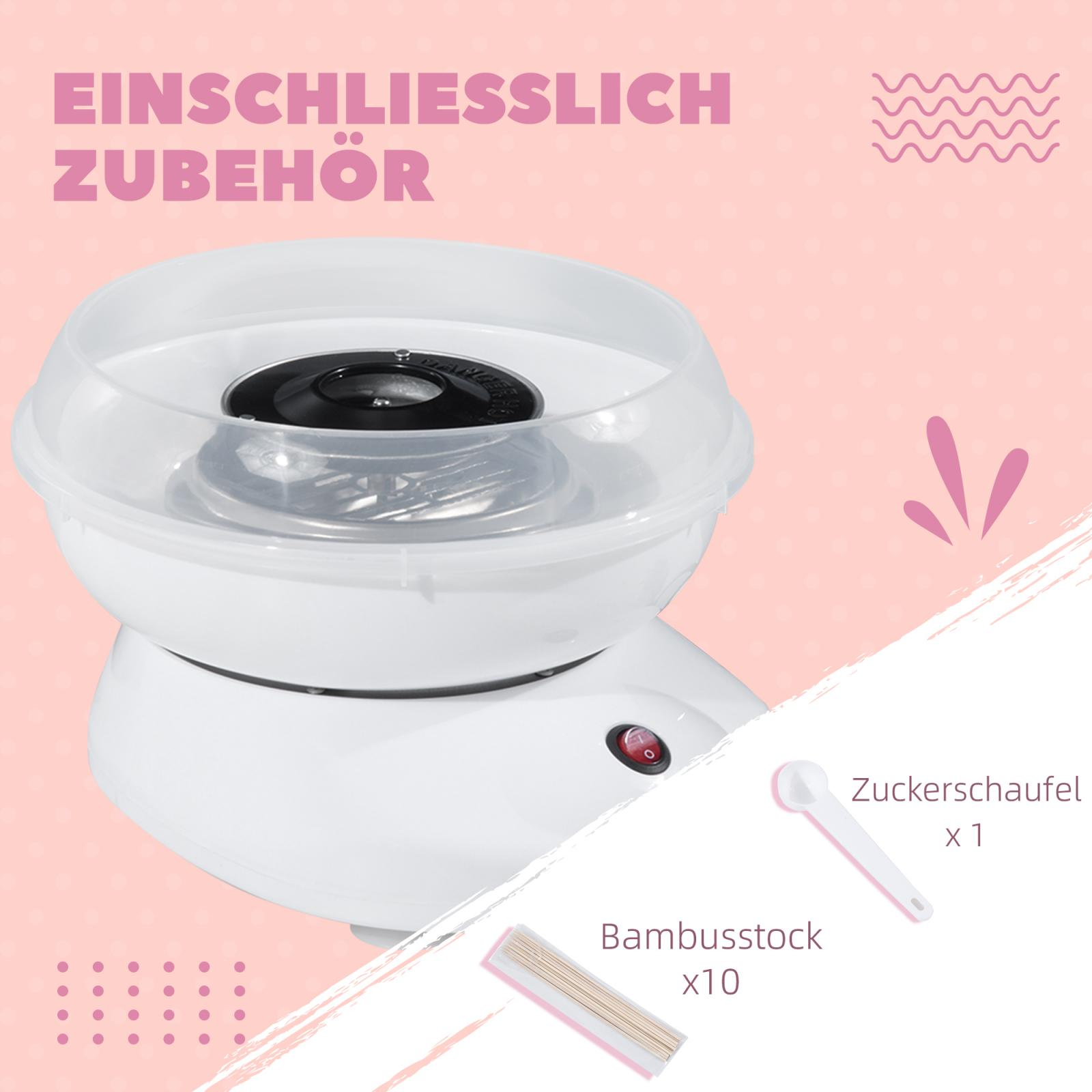 Ein weißer Zuckerwattemacher mit Zubehör wie einer Schaufel und Bambusstäben auf rosa Hintergrund.