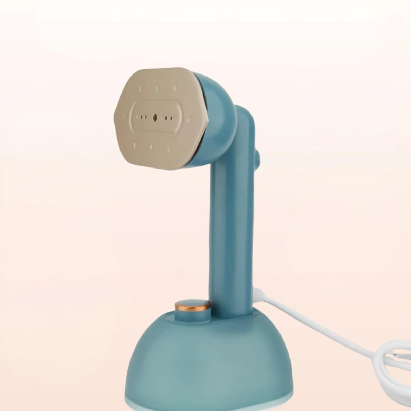 Ein teal-farbener Handdampfer mit beigem Kopf und weißem Kabel.