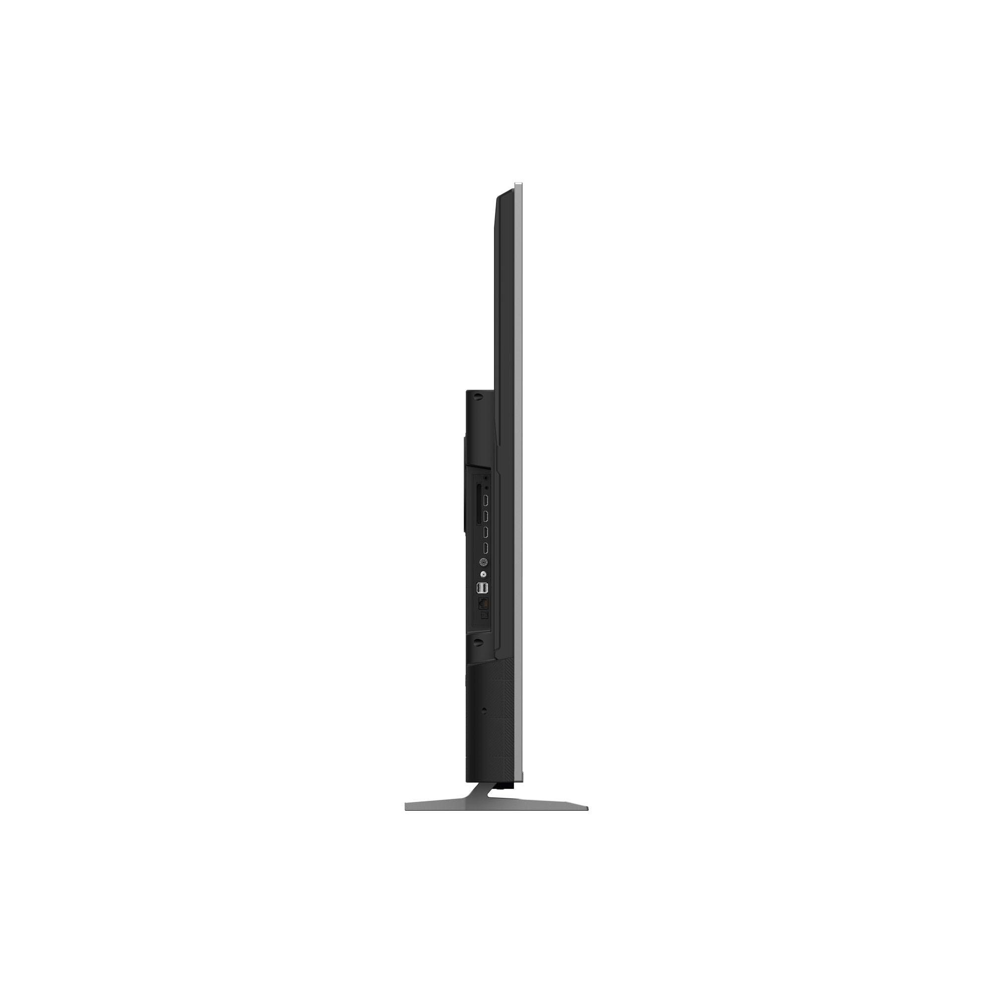 Vue latérale d'une télévision noire et fine avec des ports sur le côté. Elle repose sur un socle argenté sur fond blanc.