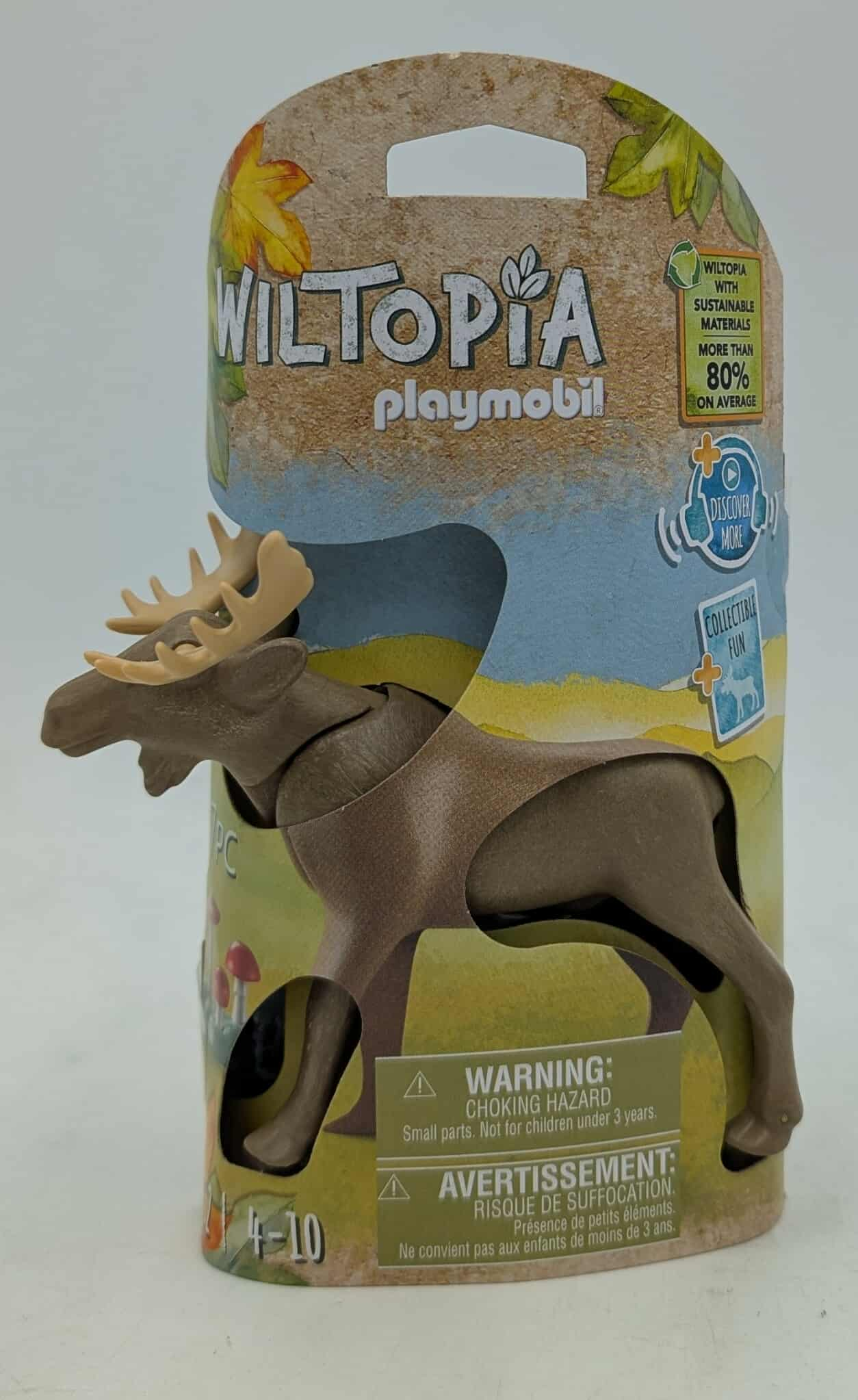 Ein Playmobil Wiltopia Elchspielzeug steht vor seiner Verpackung. Die Verpackung zeigt eine Waldszene und Warnhinweise.