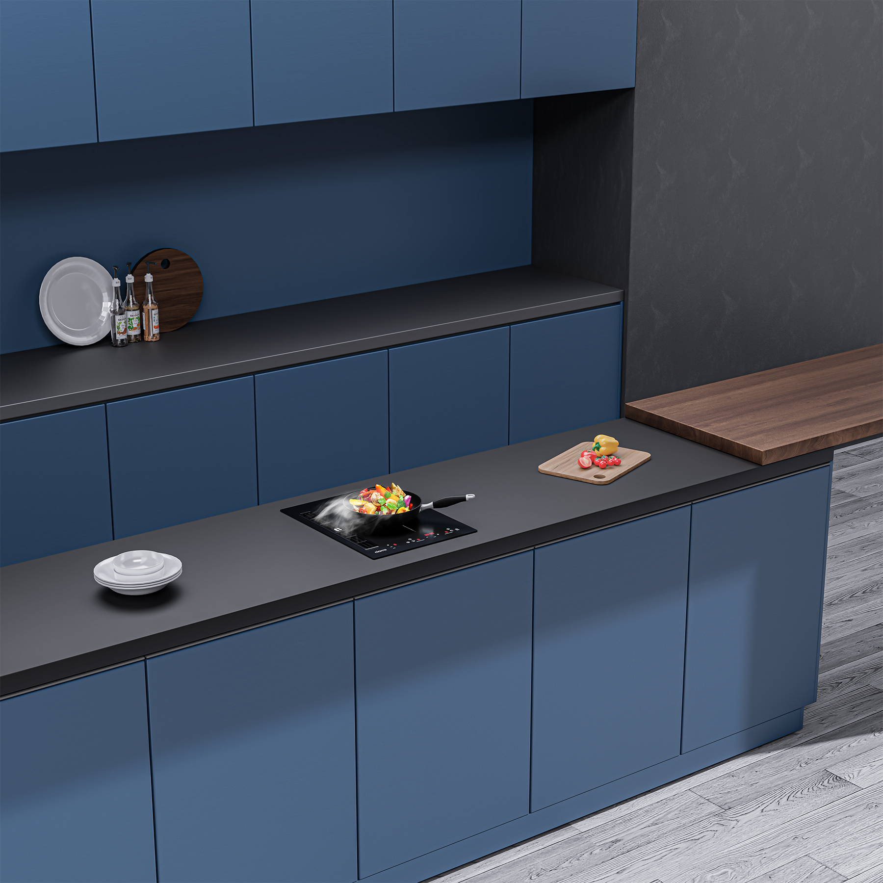 Una cucina moderna con mobili blu, un piano di lavoro nero con piano cottura e verdure in cottura.