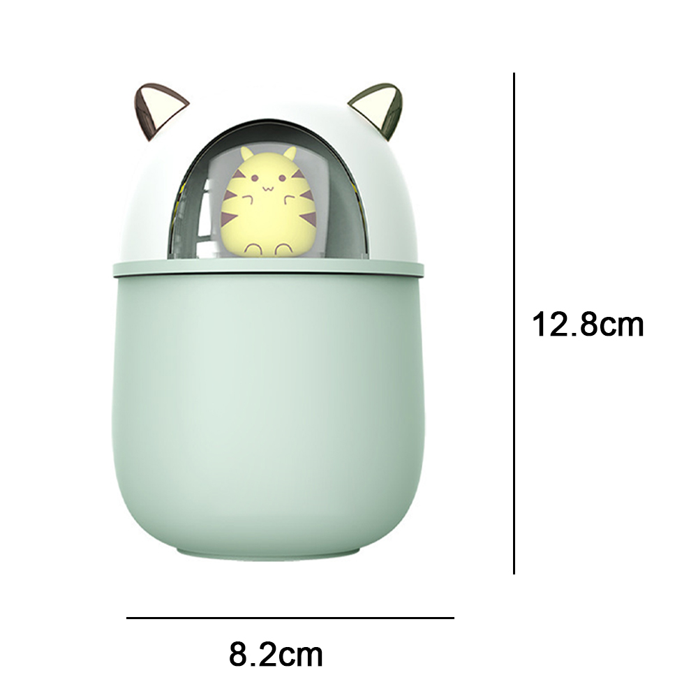 Ein mintgrüner, katzenförmiger Luftbefeuchter mit einer gelben, tigerähnlichen Figur im Inneren. Maße: 12,8 cm hoch, 8,2 cm breit.