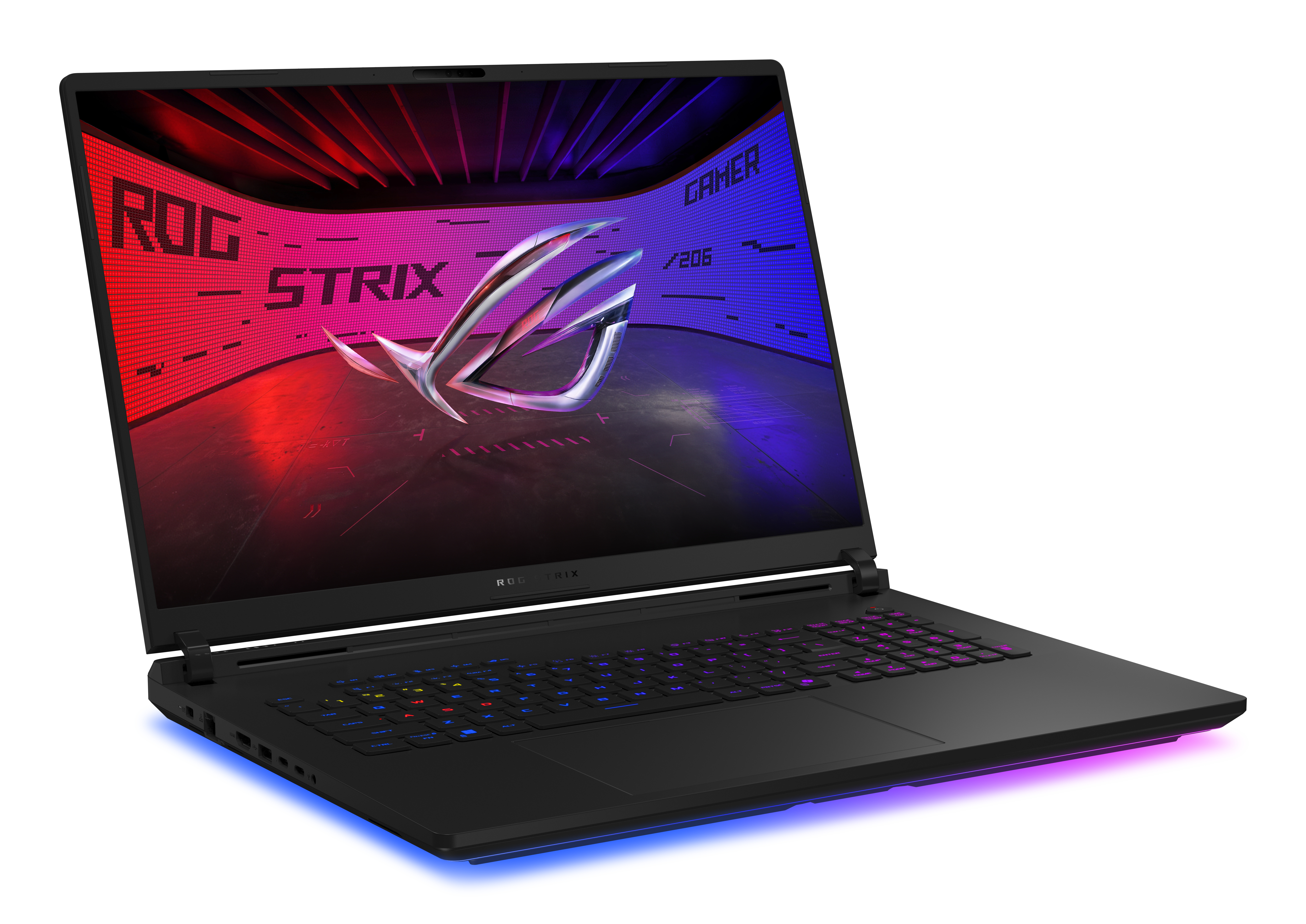 Czarny laptop z podświetlaną klawiaturą. Ekran wyświetla logo ROG STRIX. Tło jest czerwone i niebieskie.