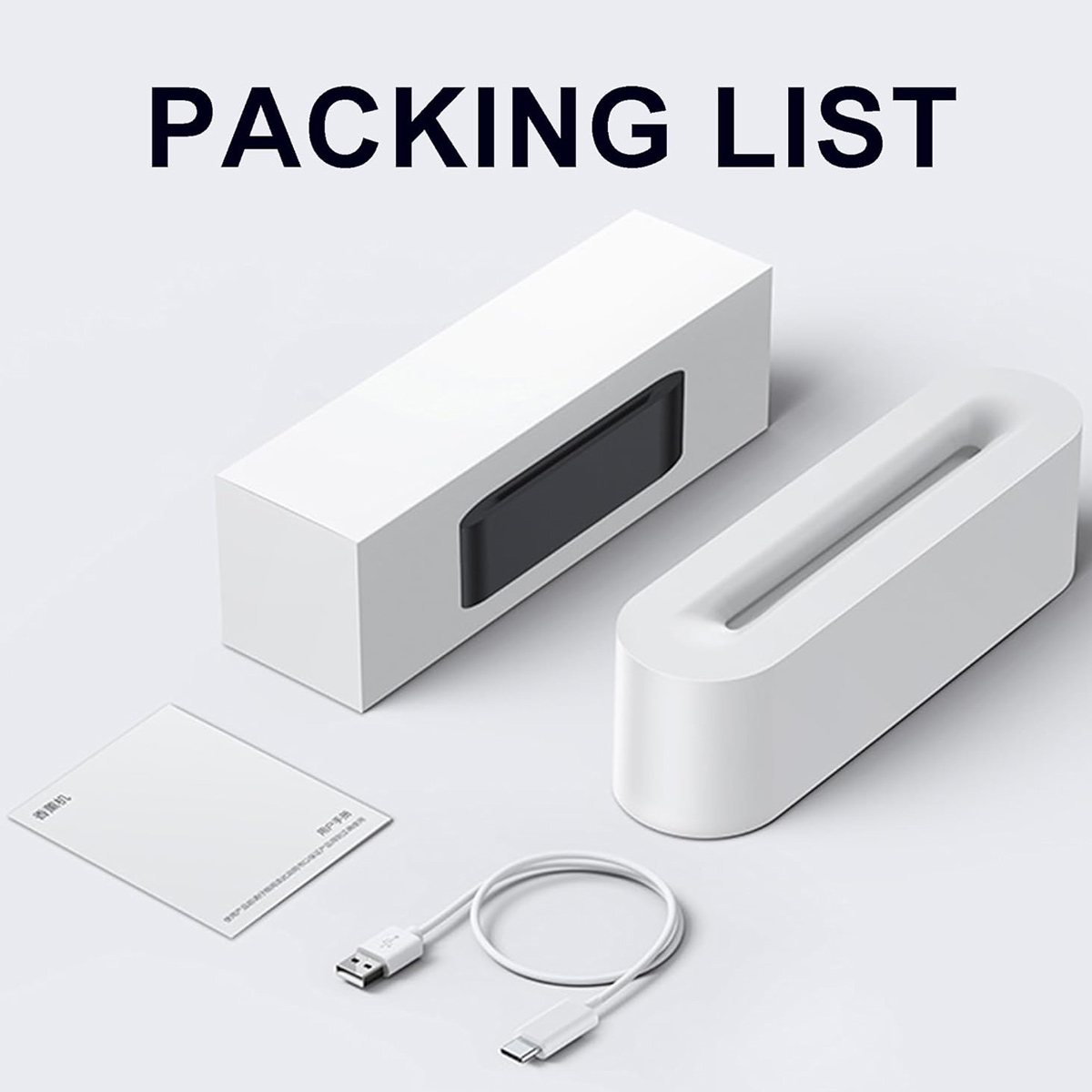 Packliste mit zwei weißen Boxen, einem Kabel und einer kleinen Karte. Die Boxen sind rechteckig, eine mit einem schwarzen Rechteck.
