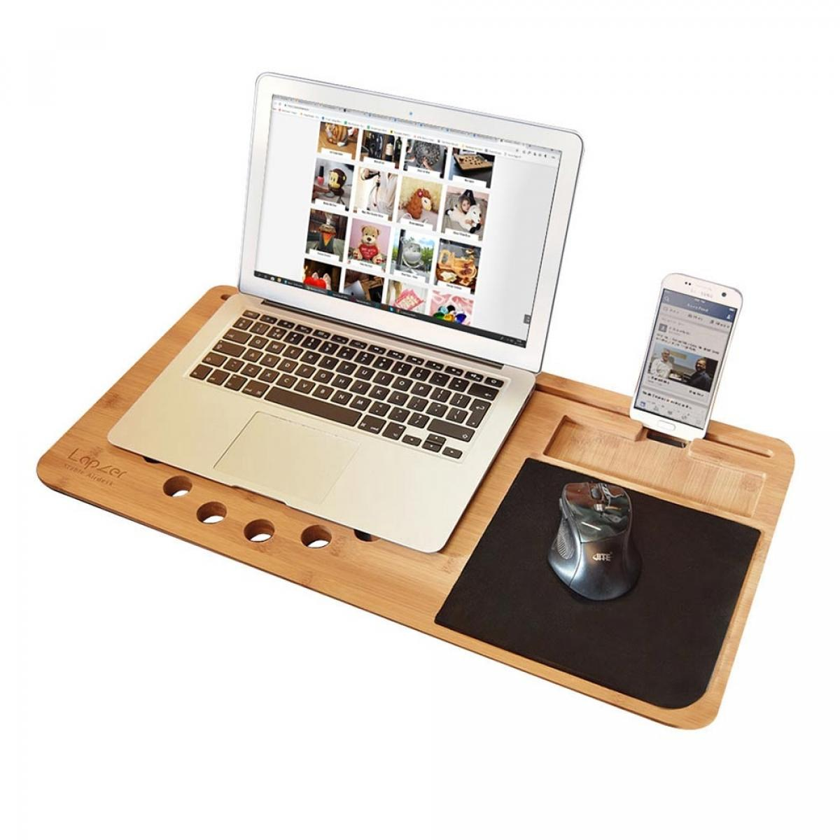 Laptop, phone, and mouse on a wooden lap desk with ventilation holes and device slots.