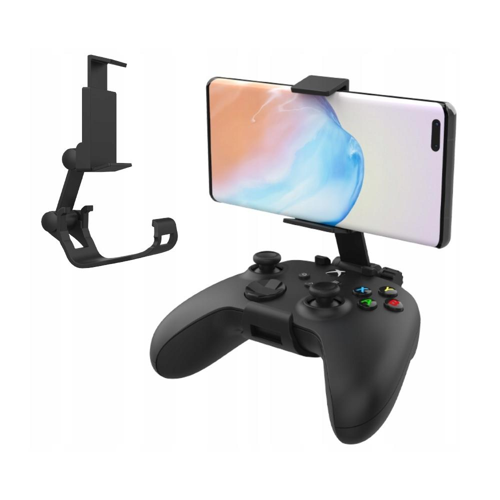 Czarny kontroler do gier z dołączonym smartfonem. Widoczny jest również osobny uchwyt na telefon. Telefon wyświetla abstrakcyjny obraz.